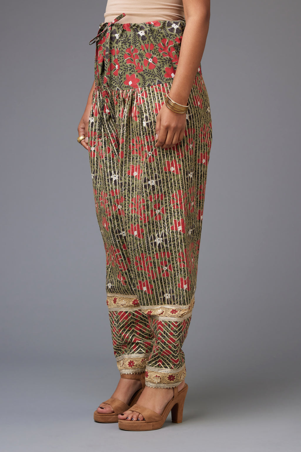 Red and green hand block printed cotton narrow salwar with all-over gota stripes.