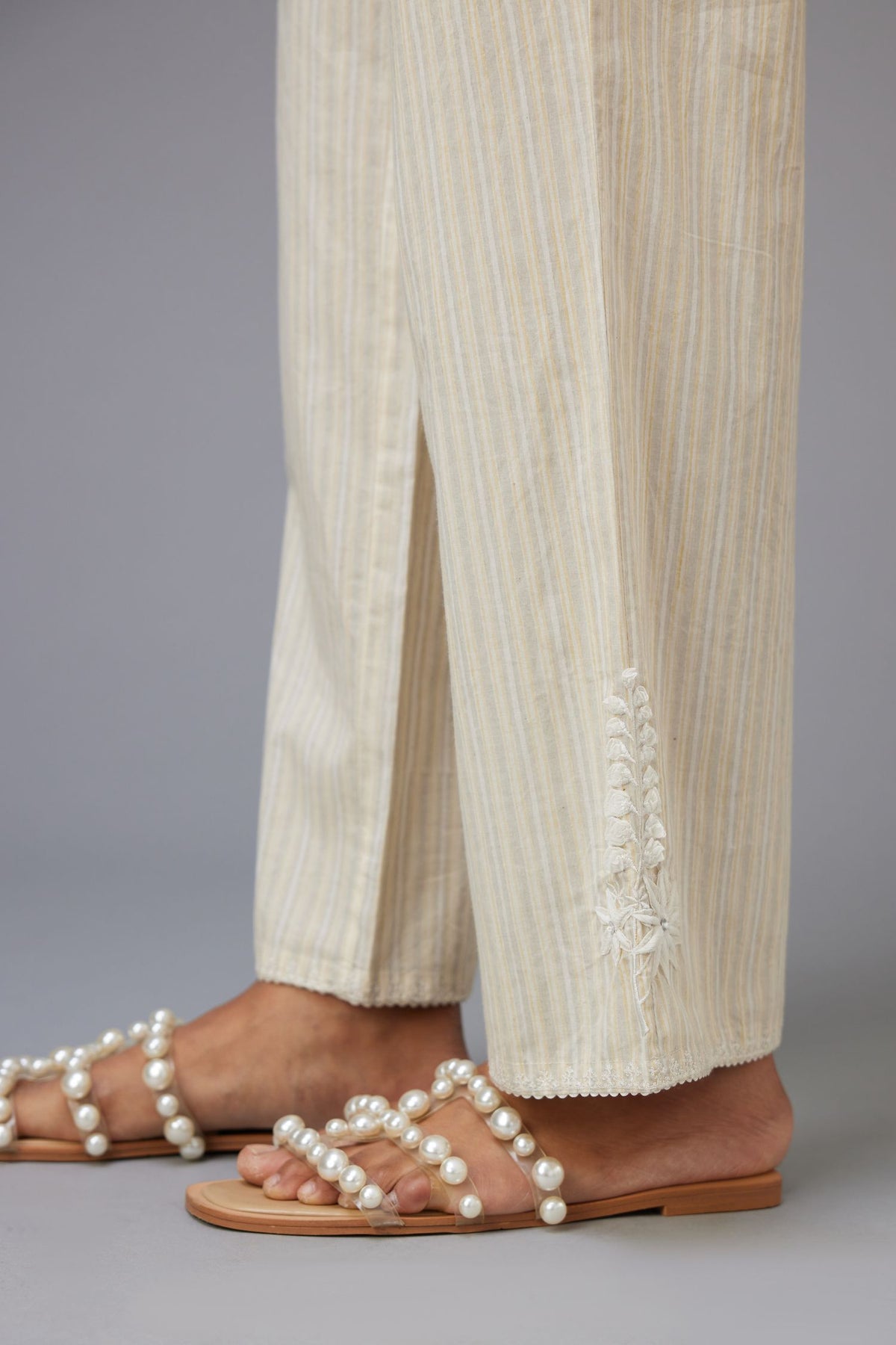 Yellow and grey stripe cotton straight pants with a chiffon embroidered boota at the hem.