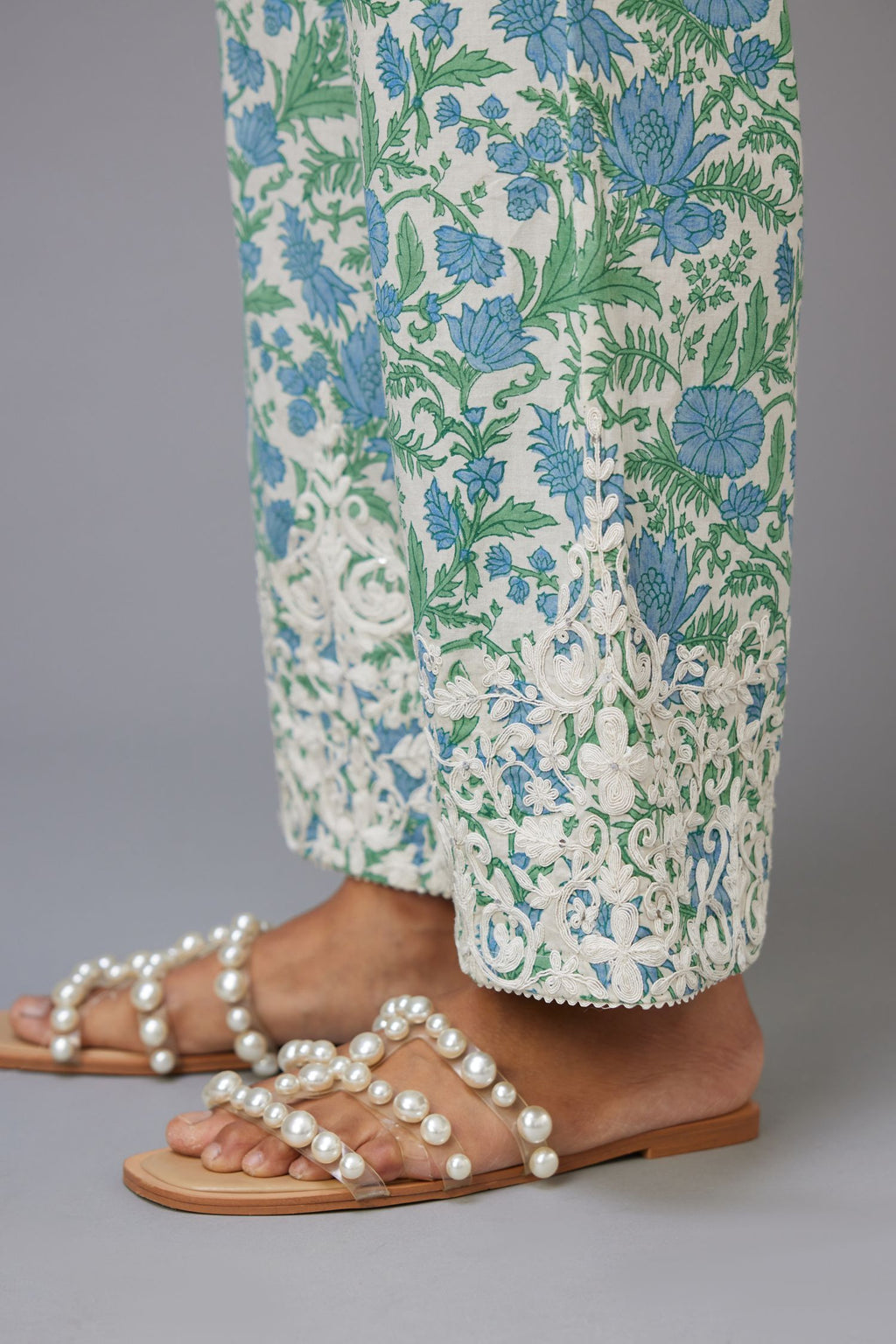 Blue and green hand block printed pants with dori embroidery at hem.