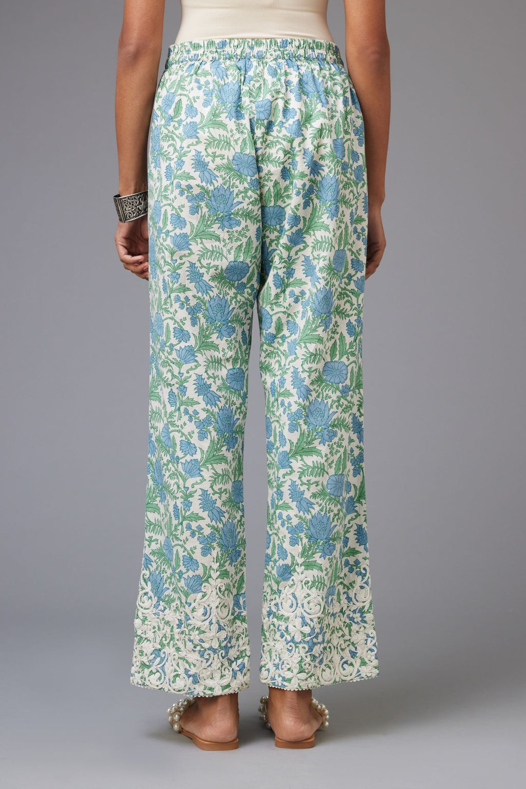 Blue and green hand block printed pants with dori embroidery at hem.