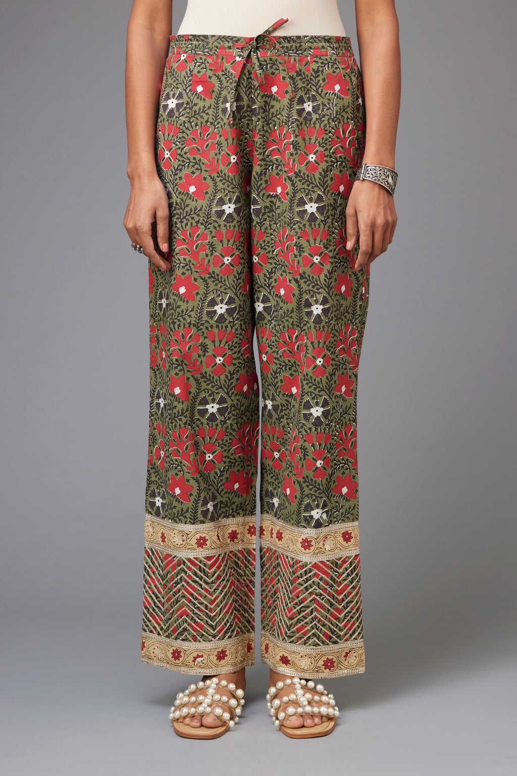 Red and green cotton hand block printed straight pants detailed with gota at the border.