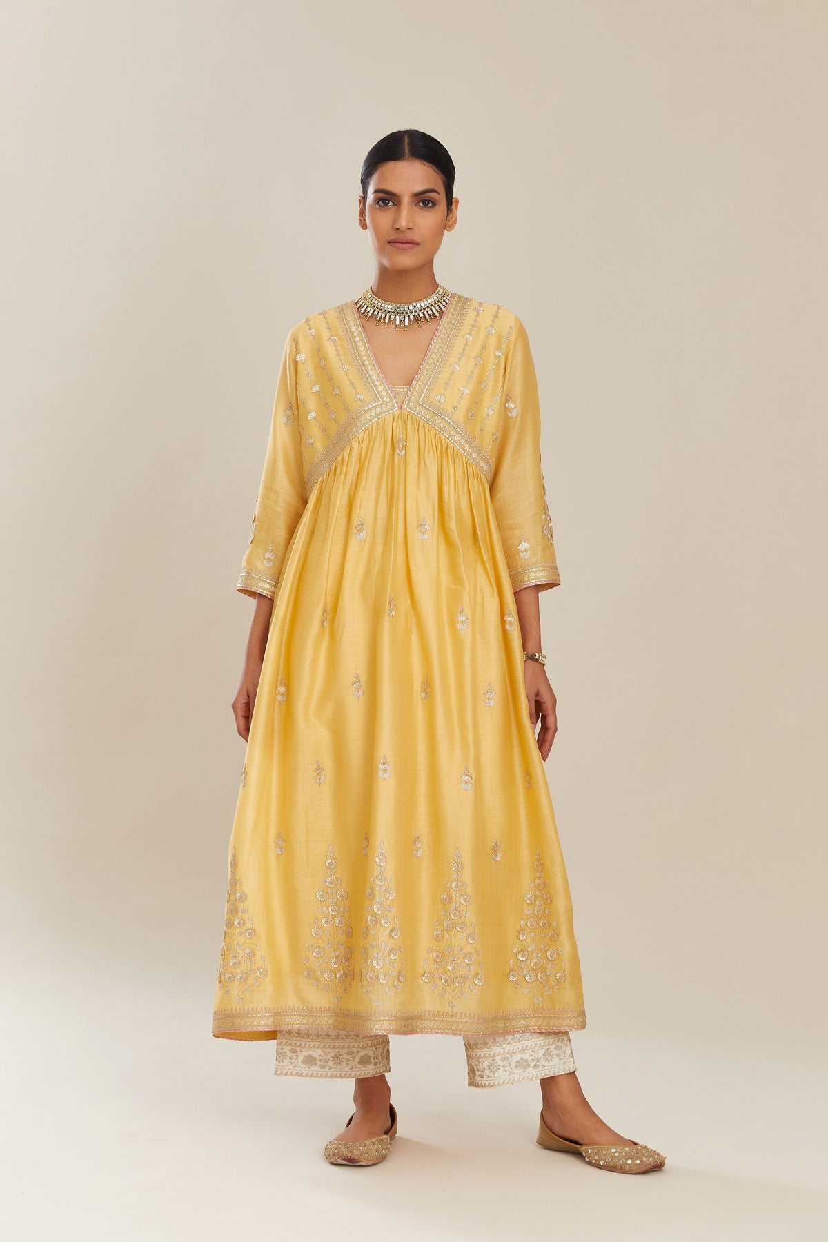 Yellow silk chanderi kurta set with heavy gold gota and zari embroidery and emroidered cotton slip inside.