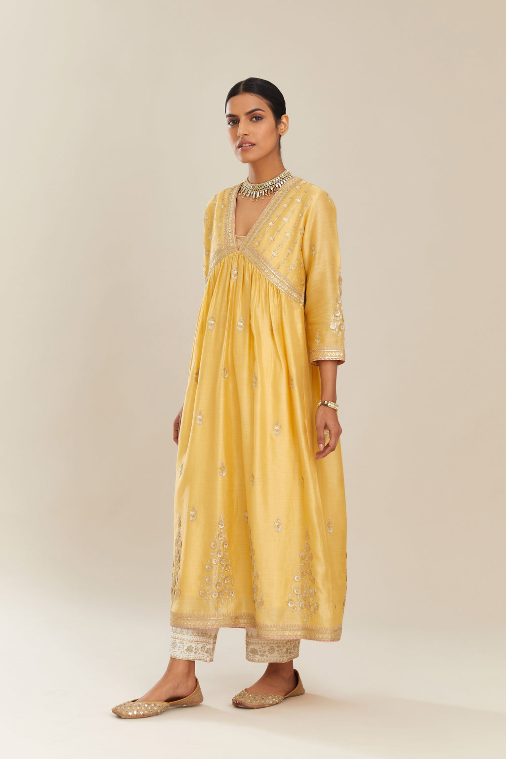 Yellow silk chanderi kurta set with heavy gold gota and zari embroidery and emroidered cotton slip inside.