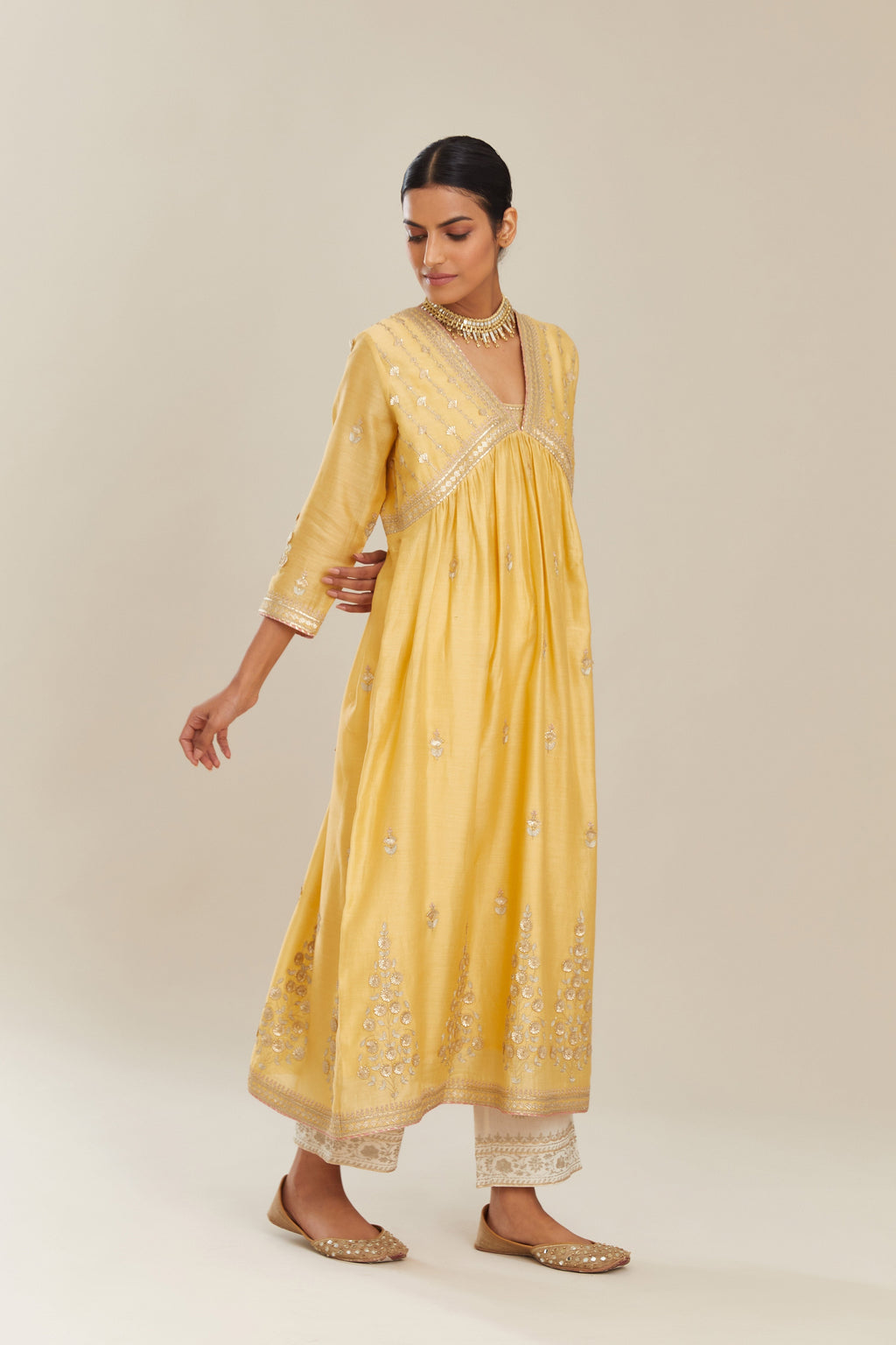 Yellow silk chanderi kurta set with heavy gold gota and zari embroidery and emroidered cotton slip inside.