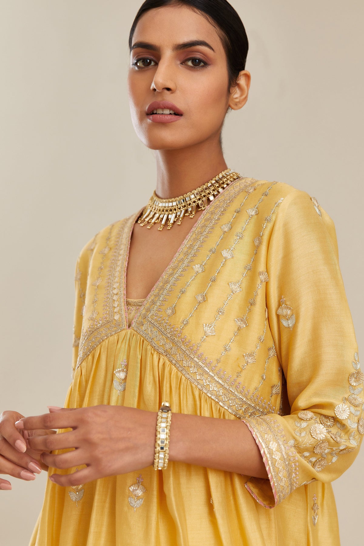 Yellow silk chanderi kurta set with heavy gold gota and zari embroidery and emroidered cotton slip inside.