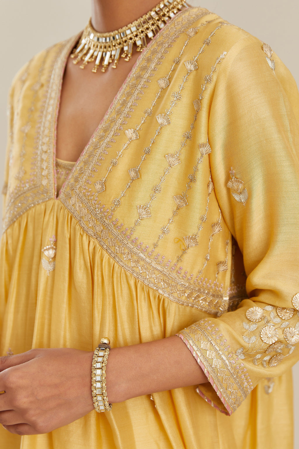 Yellow silk chanderi kurta set with heavy gold gota and zari embroidery and emroidered cotton slip inside.