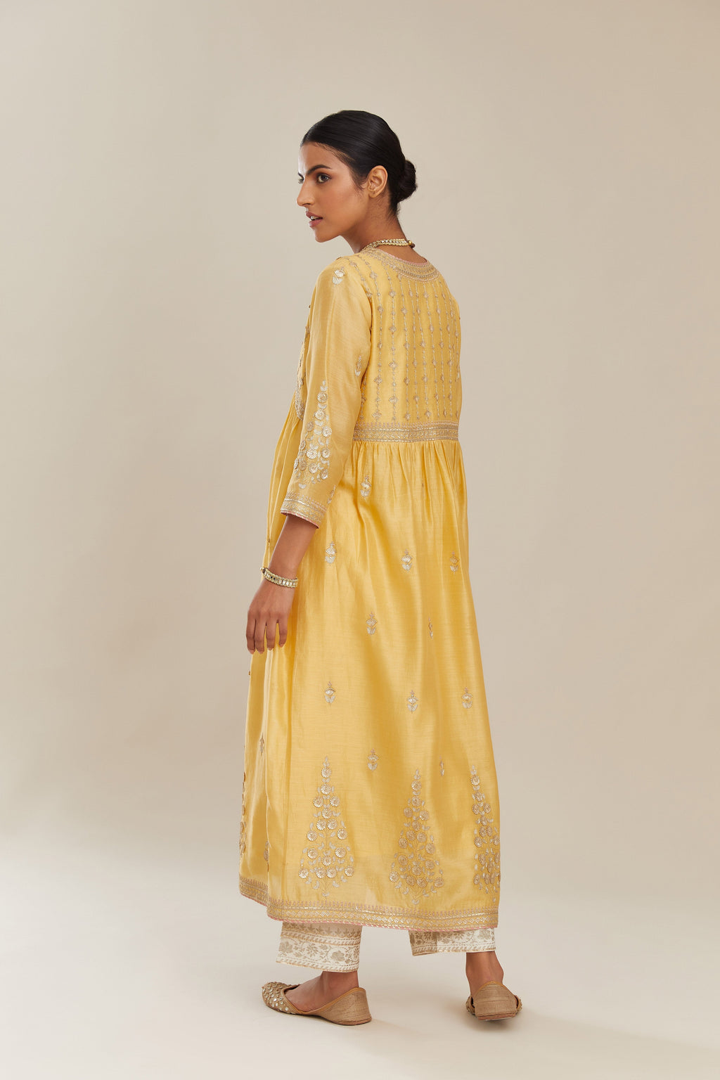 Yellow silk chanderi kurta set with heavy gold gota and zari embroidery and emroidered cotton slip inside.