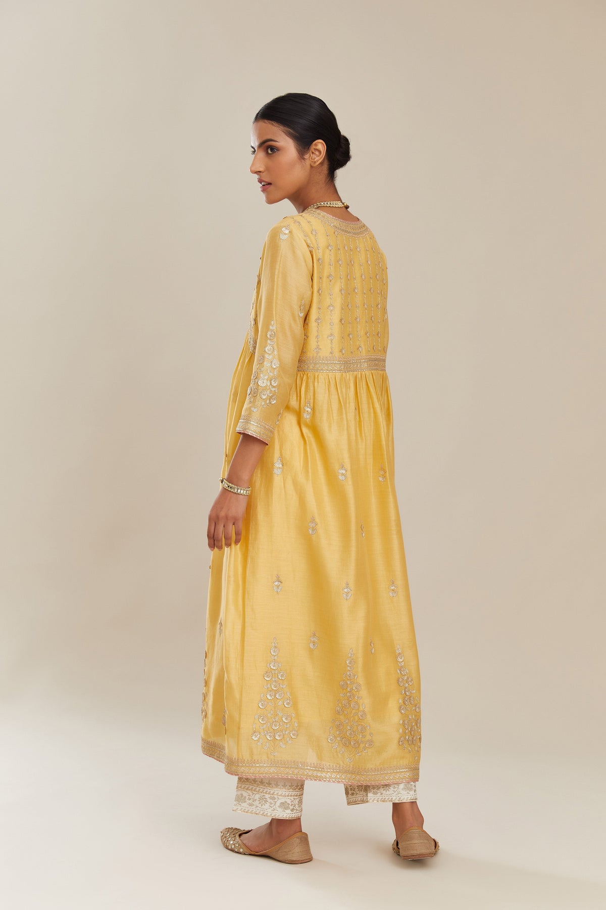 Yellow silk chanderi kurta set with heavy gold gota and zari embroidery and emroidered cotton slip inside.
