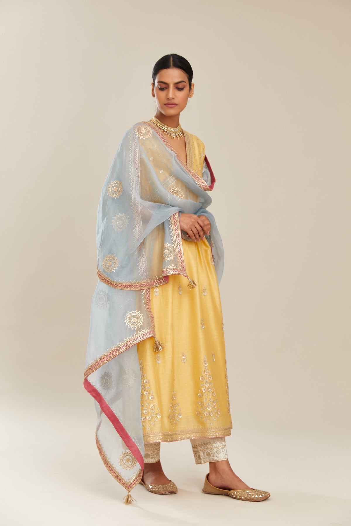 Yellow silk chanderi kurta set with heavy gold gota and zari embroidery and emroidered cotton slip inside.
