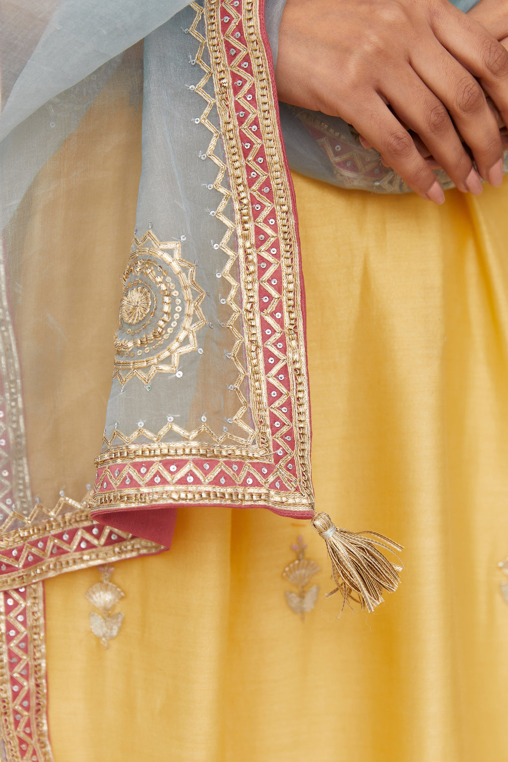 Blue silk organza dupatta with delicate gold gota embroidery and contrast colored border running along all edges.