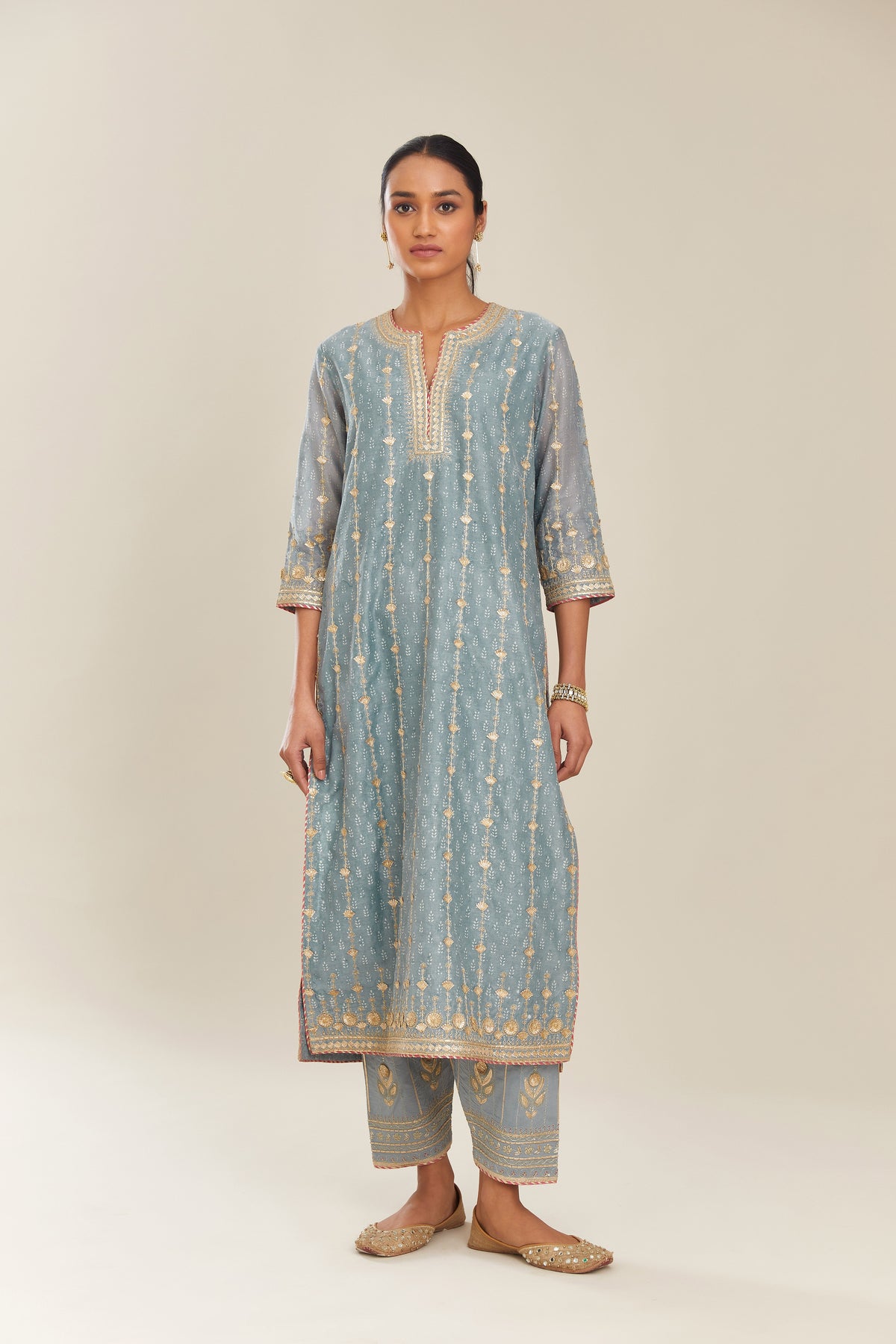 Powder blue hand block printed silk chanderi straight kurta set with all over heavy gold gota and zari embroidery.