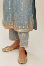 Powder blue hand block printed silk chanderi straight kurta set with all over heavy gold gota and zari embroidery.