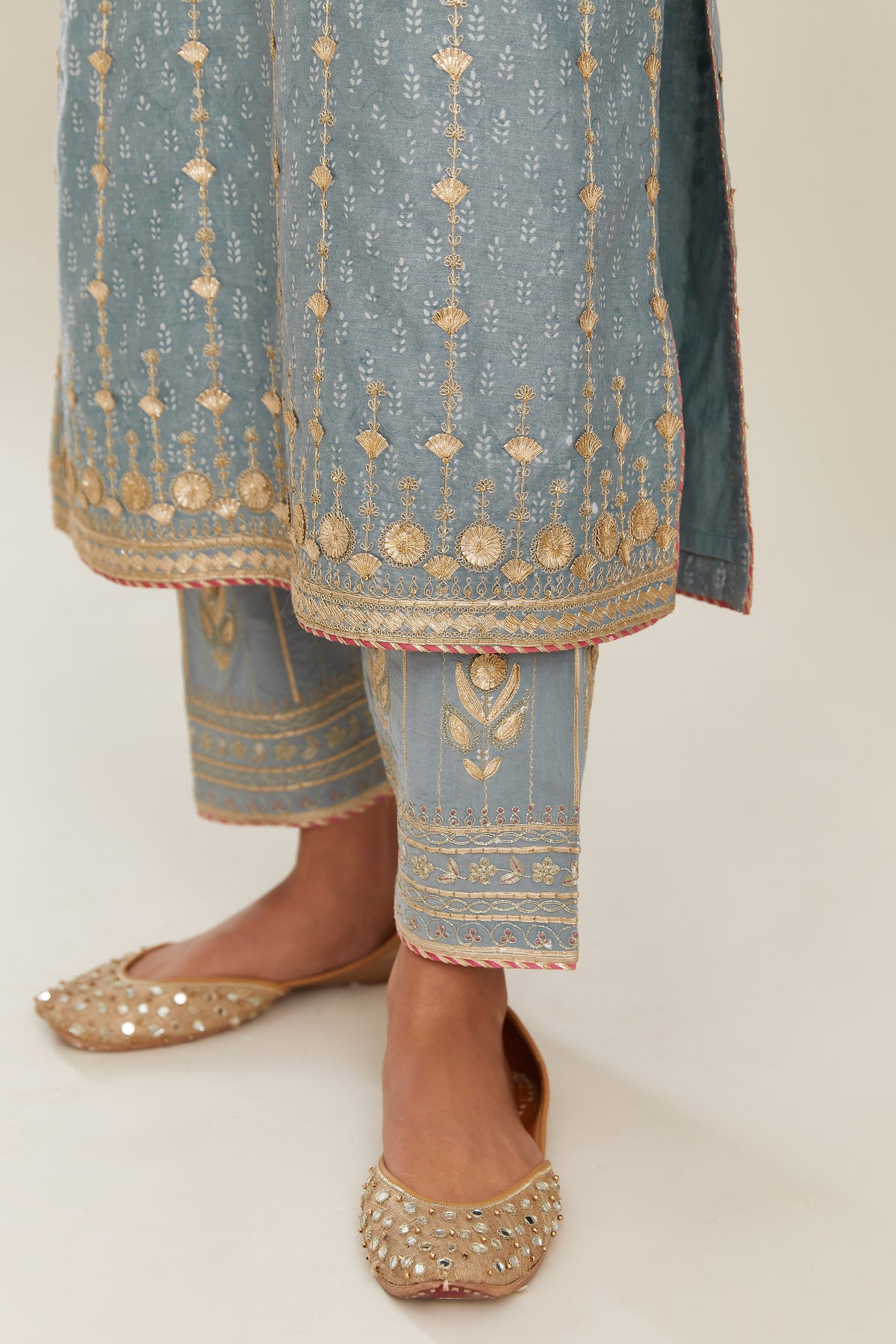 Powder blue hand block printed silk chanderi straight kurta set with all over heavy gold gota and zari embroidery.
