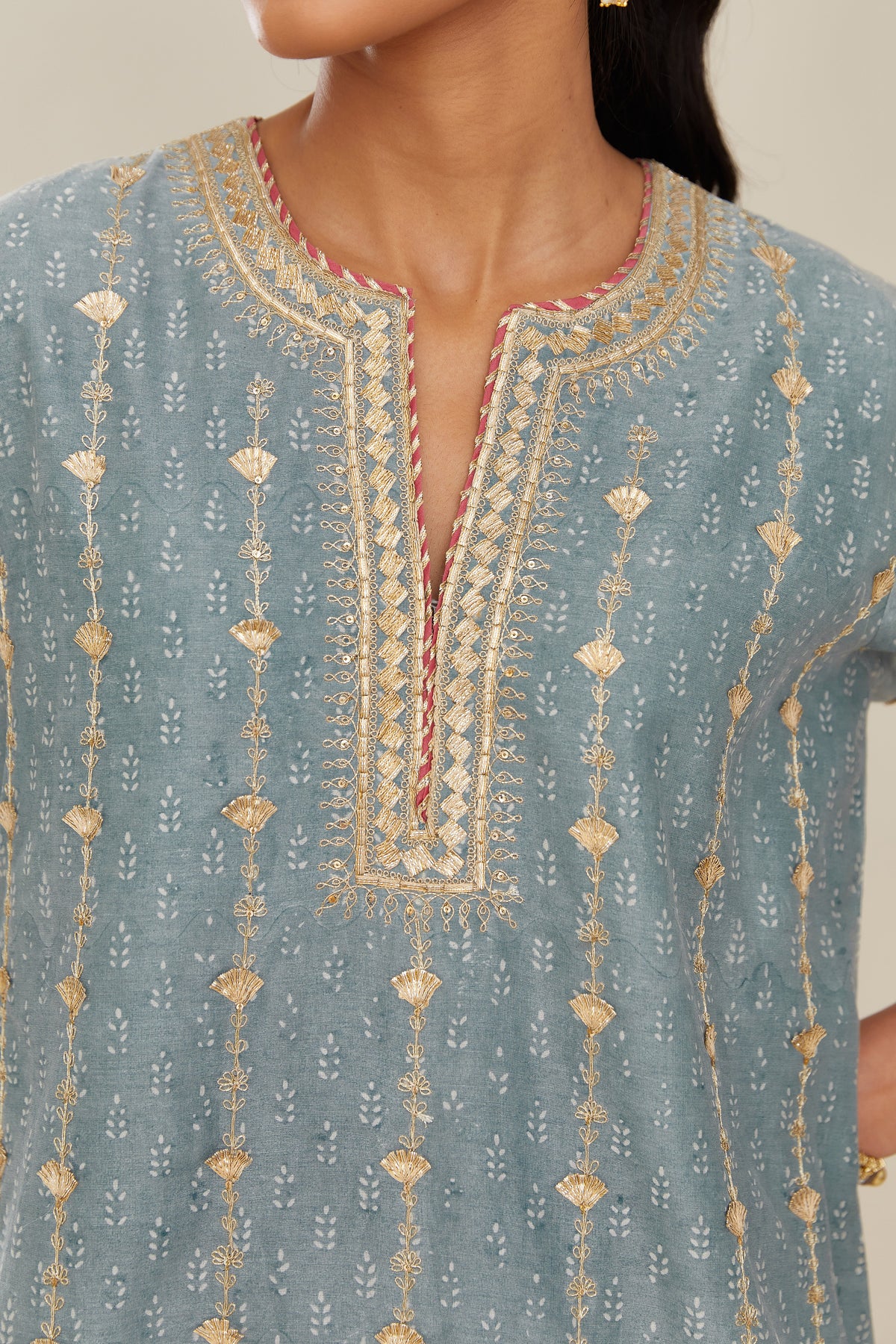 Powder blue hand block printed silk chanderi straight kurta set with all over heavy gold gota and zari embroidery.