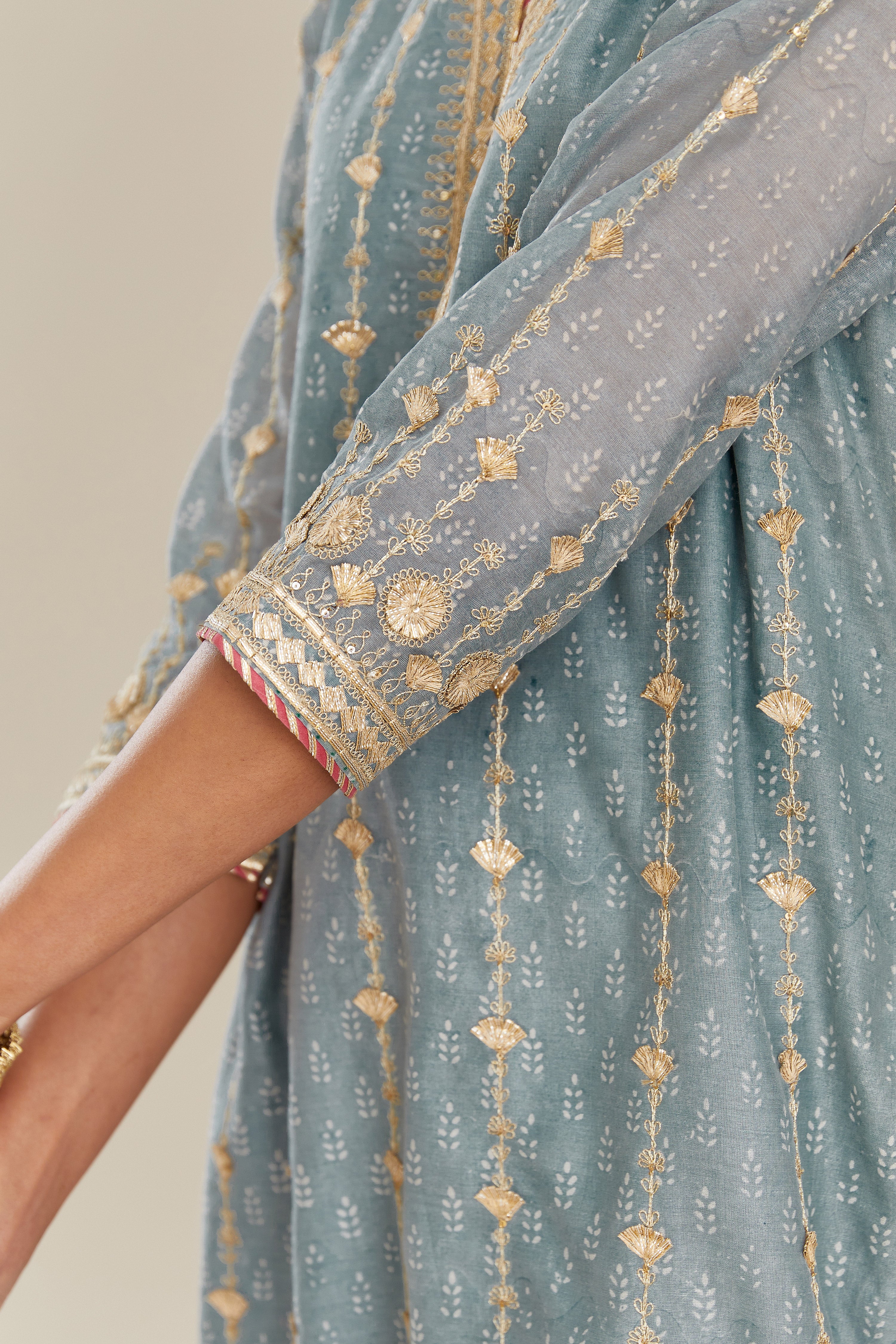 Powder blue hand block printed silk chanderi straight kurta set with all over heavy gold gota and zari embroidery.