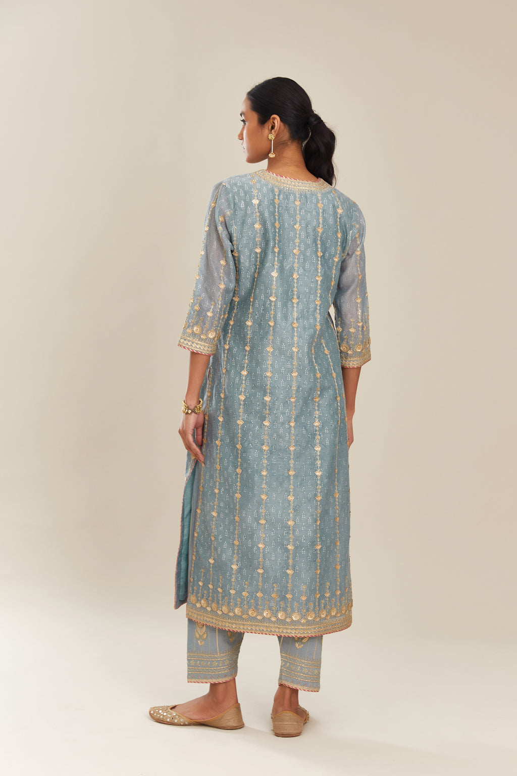 Powder blue hand block printed silk chanderi straight kurta set with all over heavy gold gota and zari embroidery.