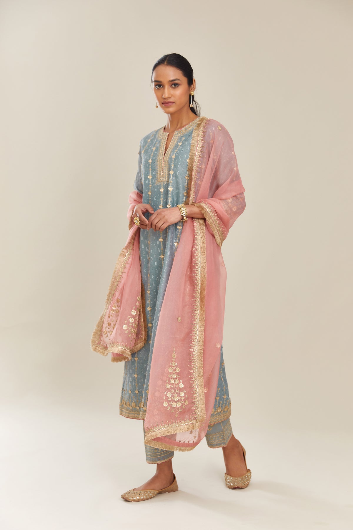 Powder blue hand block printed silk chanderi straight kurta set with all over heavy gold gota and zari embroidery.