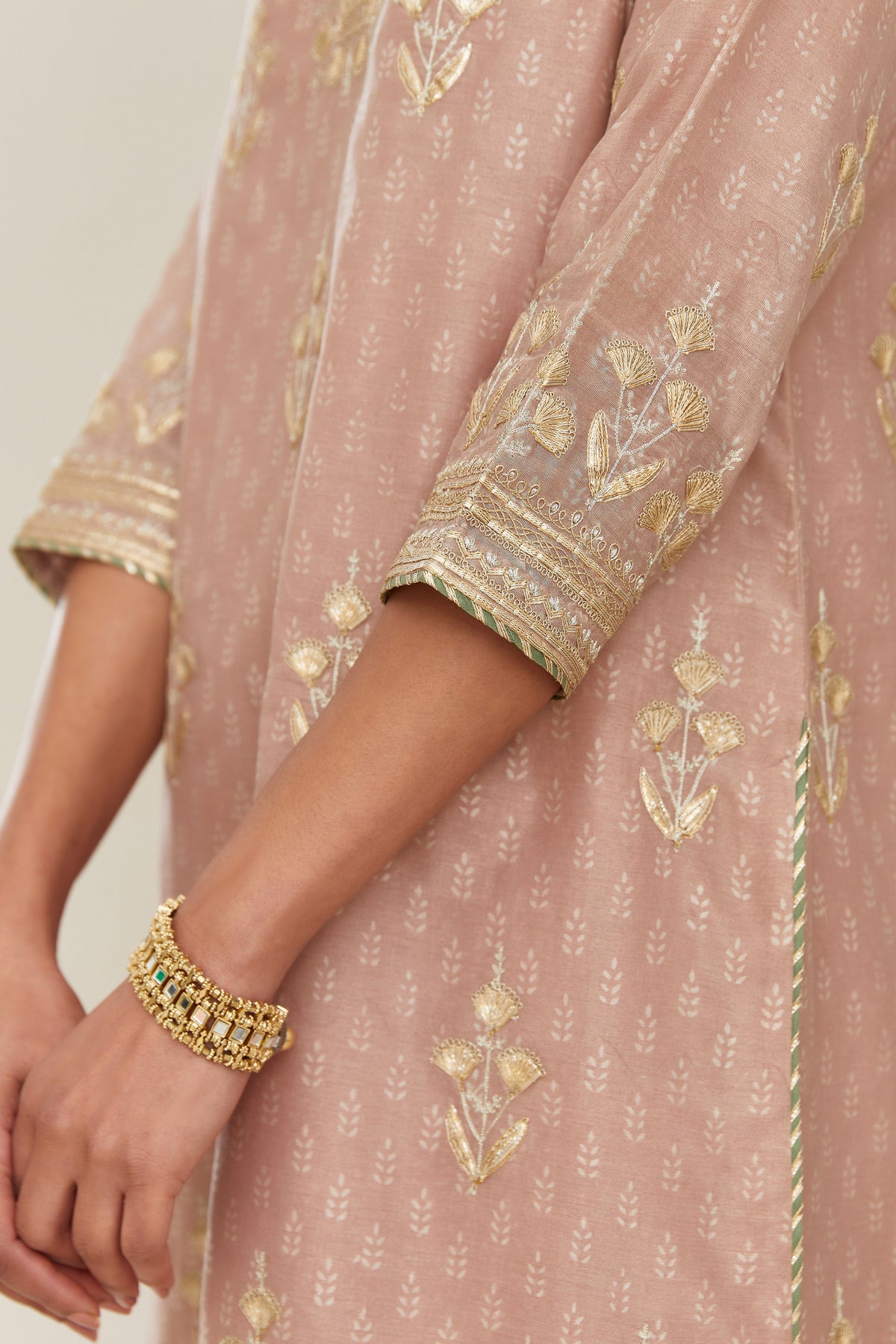 Old rose hand block printed silk chanderi kurta set with gold gota and zari embroidery butas and heavy borders at hem.