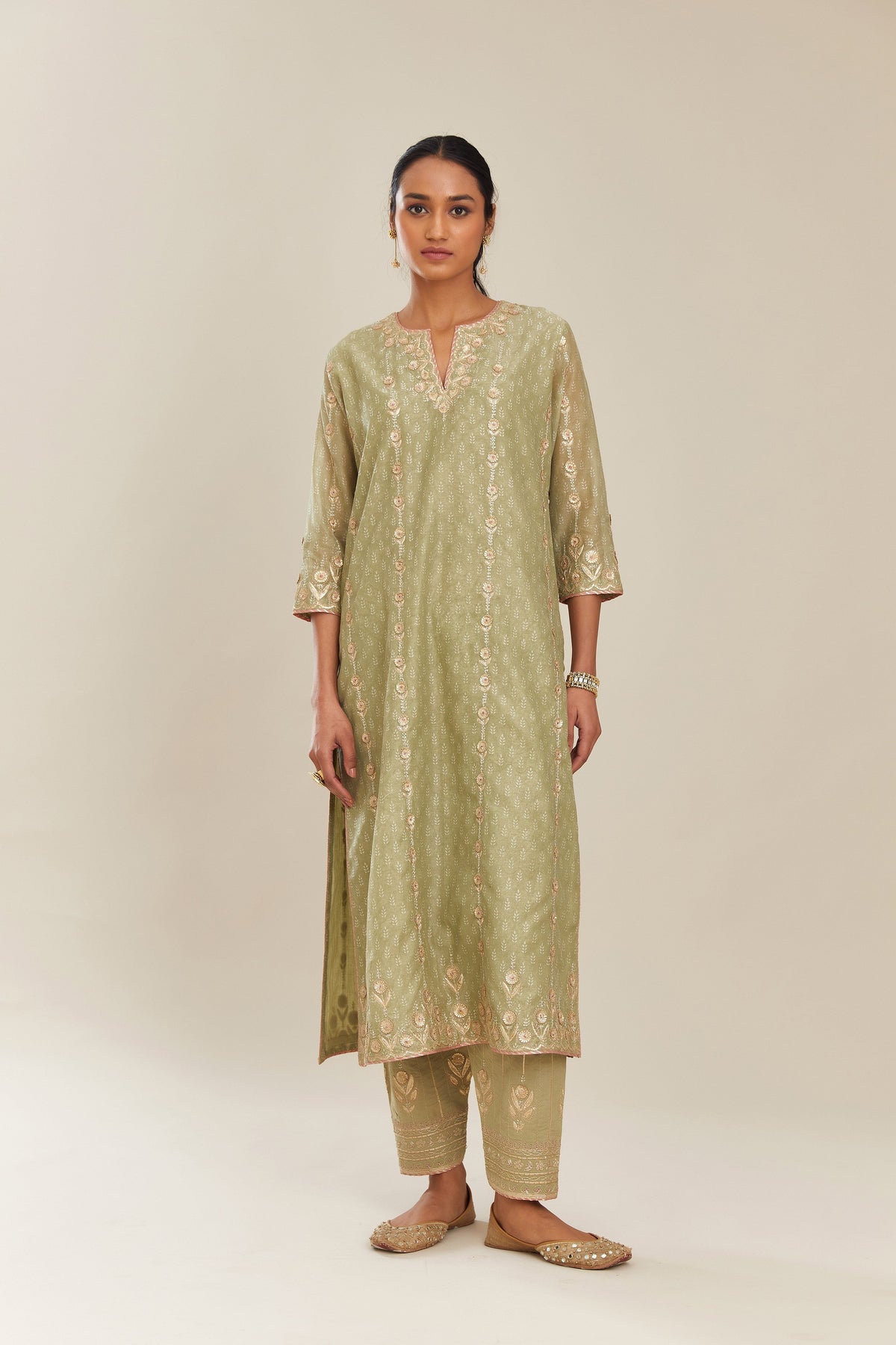 Sage green hand block printed silk chanderi straight kurta set with all over gold gota and zari embroidery.