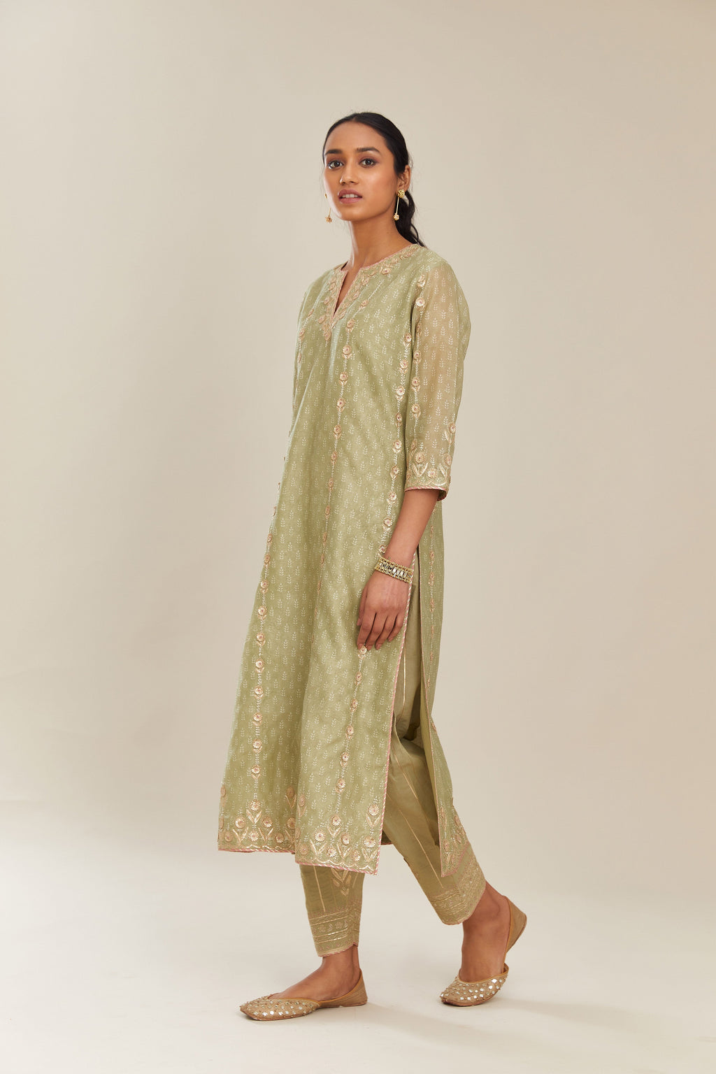 Sage green hand block printed silk chanderi straight kurta set with all over gold gota and zari embroidery.