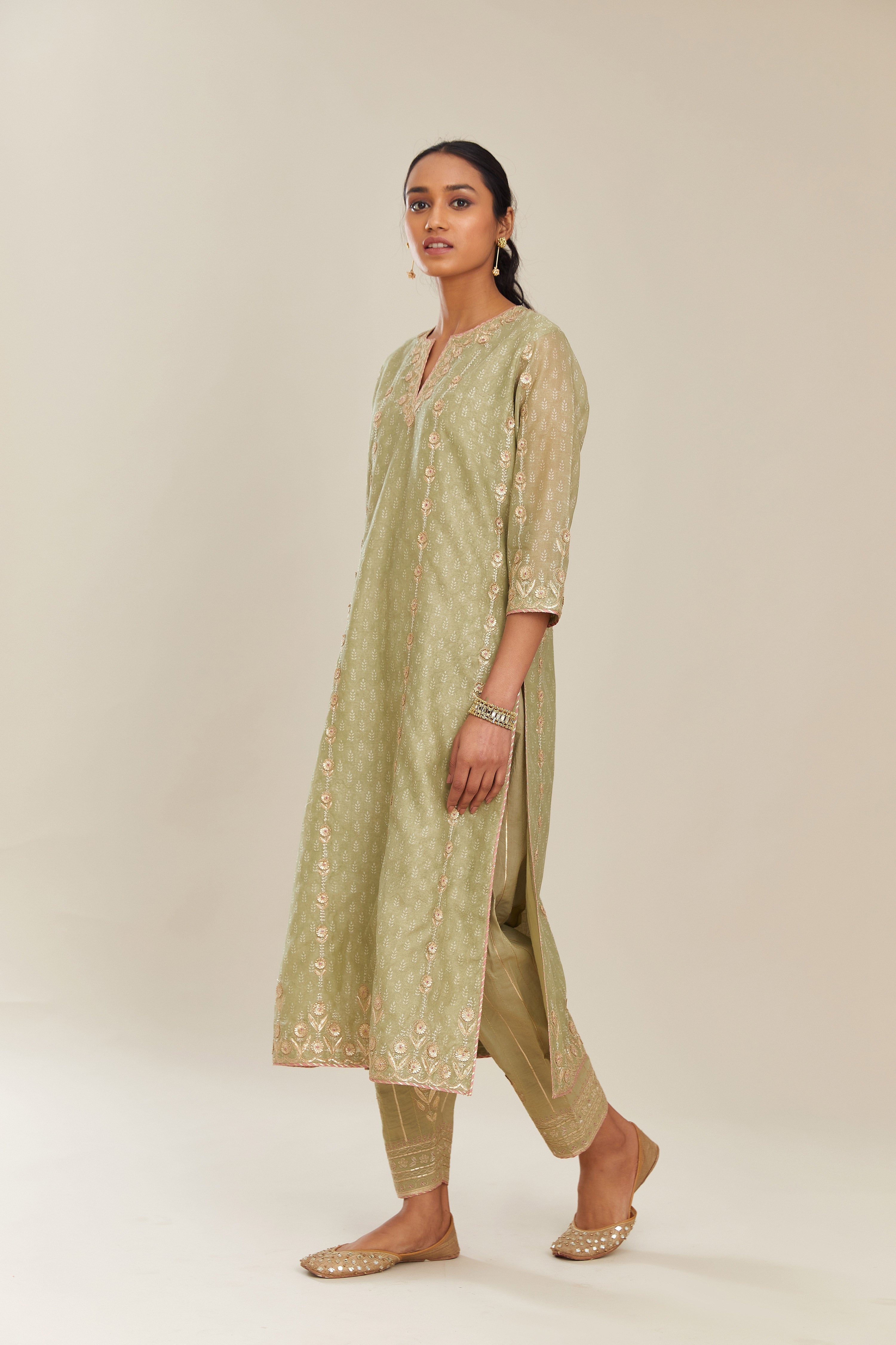 Sage green hand block printed silk chanderi straight kurta set with all over gold gota and zari embroidery.