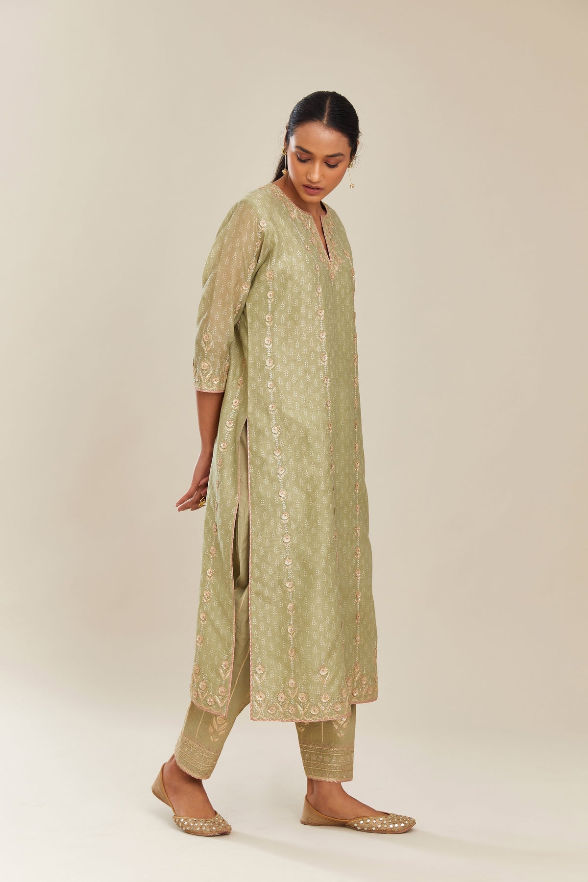 Sage green hand block printed silk chanderi straight kurta set with all over gold gota and zari embroidery.