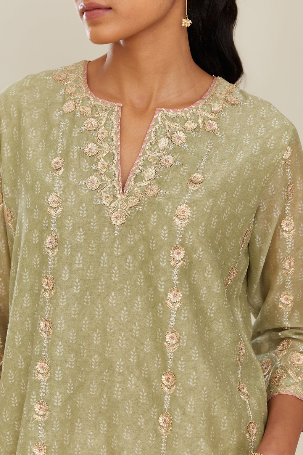 Sage green hand block printed silk chanderi straight kurta set with all over gold gota and zari embroidery.