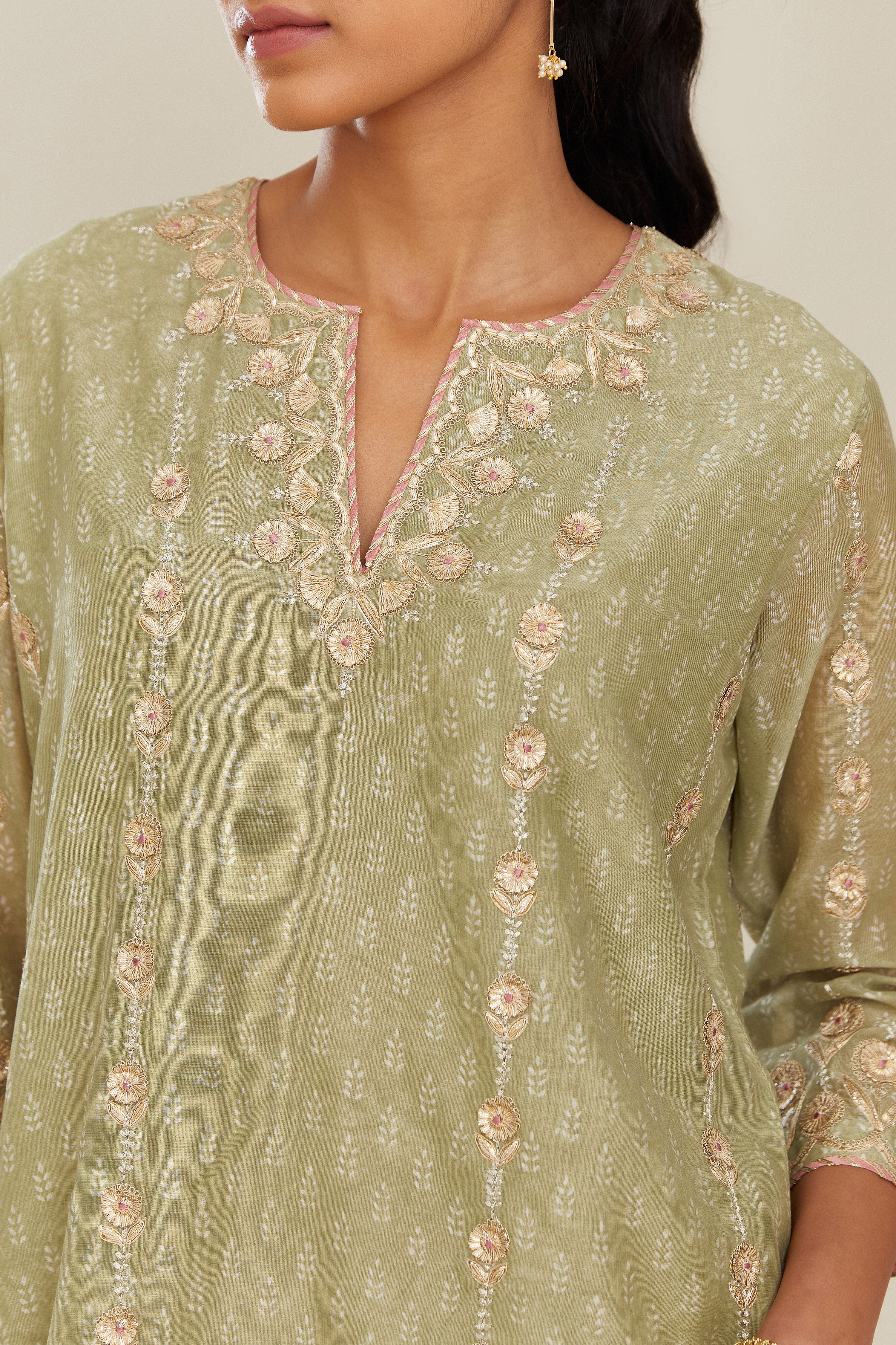 Sage green hand block printed silk chanderi straight kurta set with all over gold gota and zari embroidery.