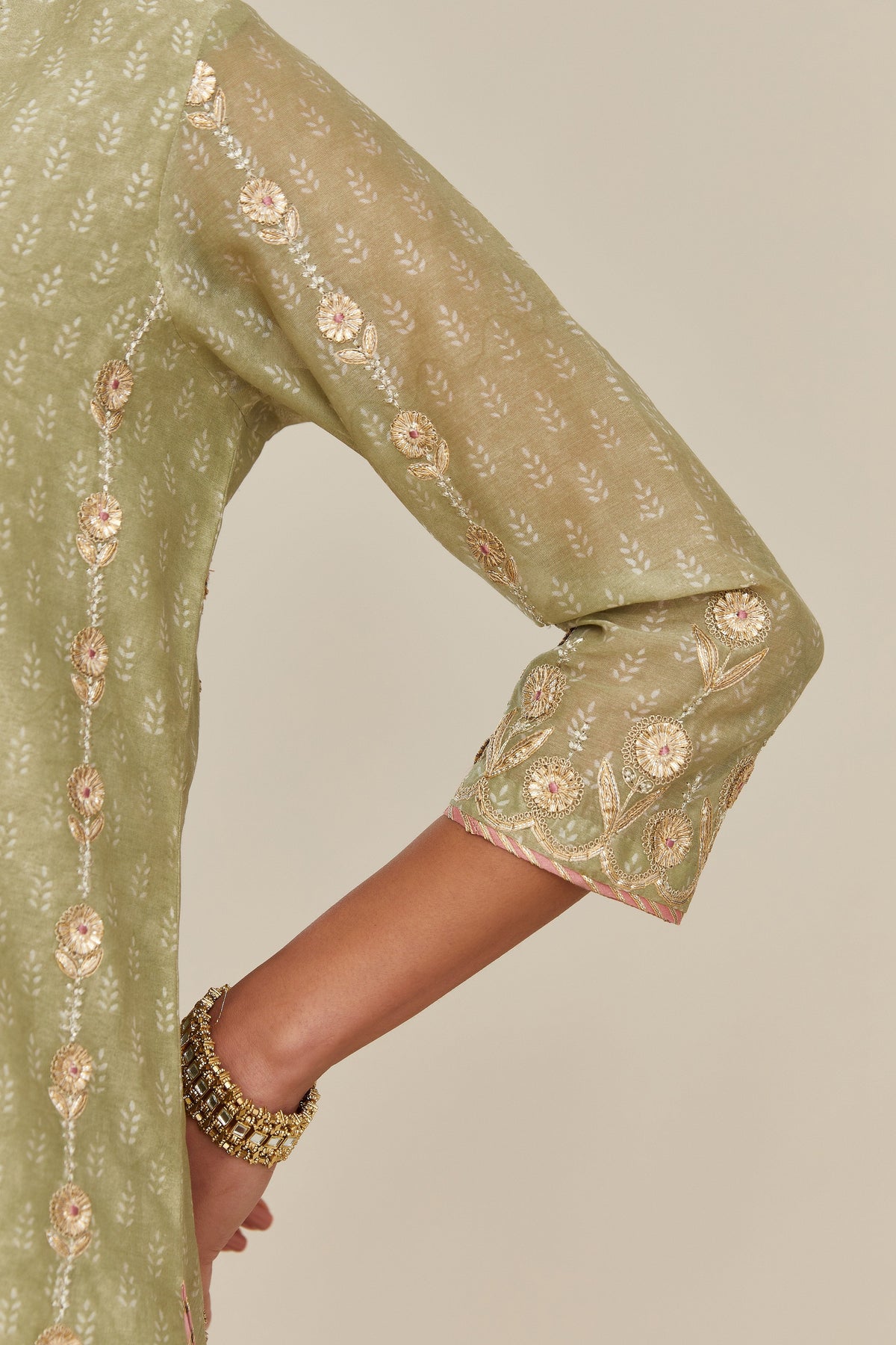 Sage green hand block printed silk chanderi straight kurta set with all over gold gota and zari embroidery.