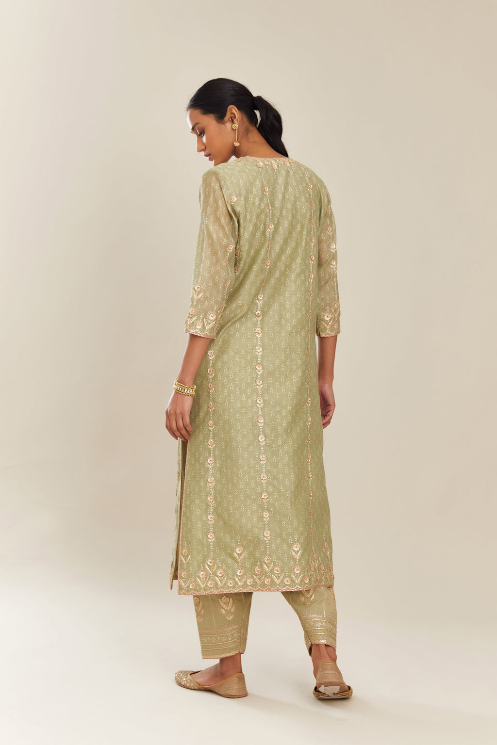 Sage green hand block printed silk chanderi straight kurta set with all over gold gota and zari embroidery.
