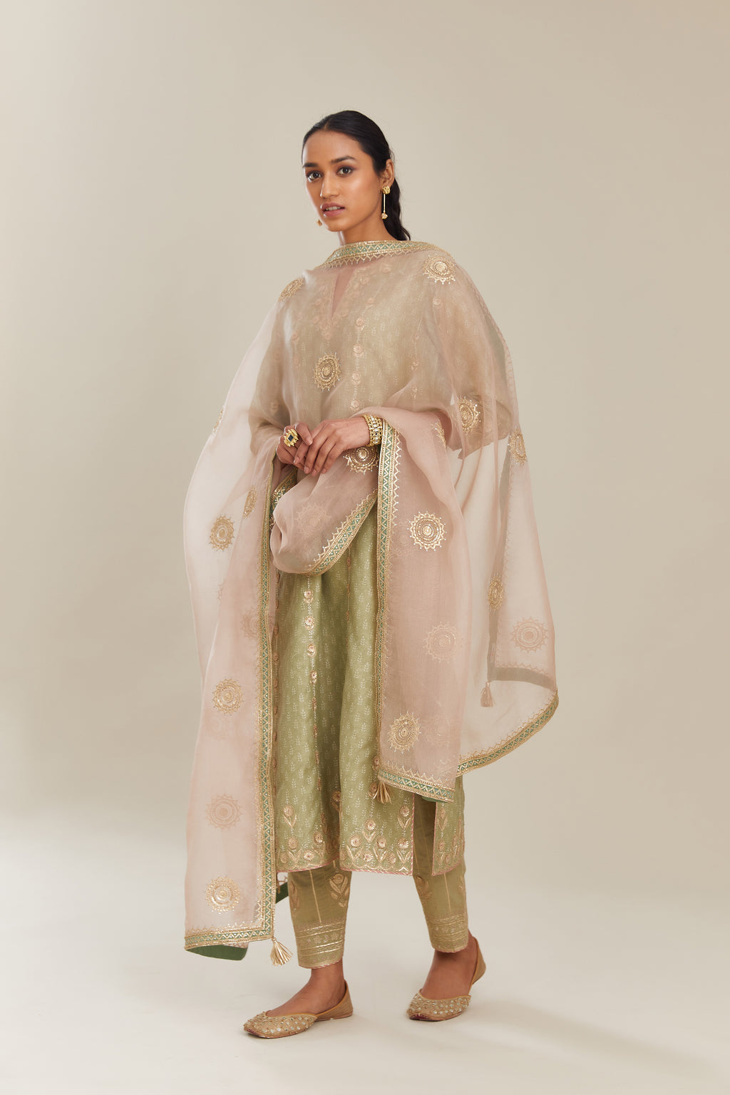 Sage green hand block printed silk chanderi straight kurta set with all over gold gota and zari embroidery.