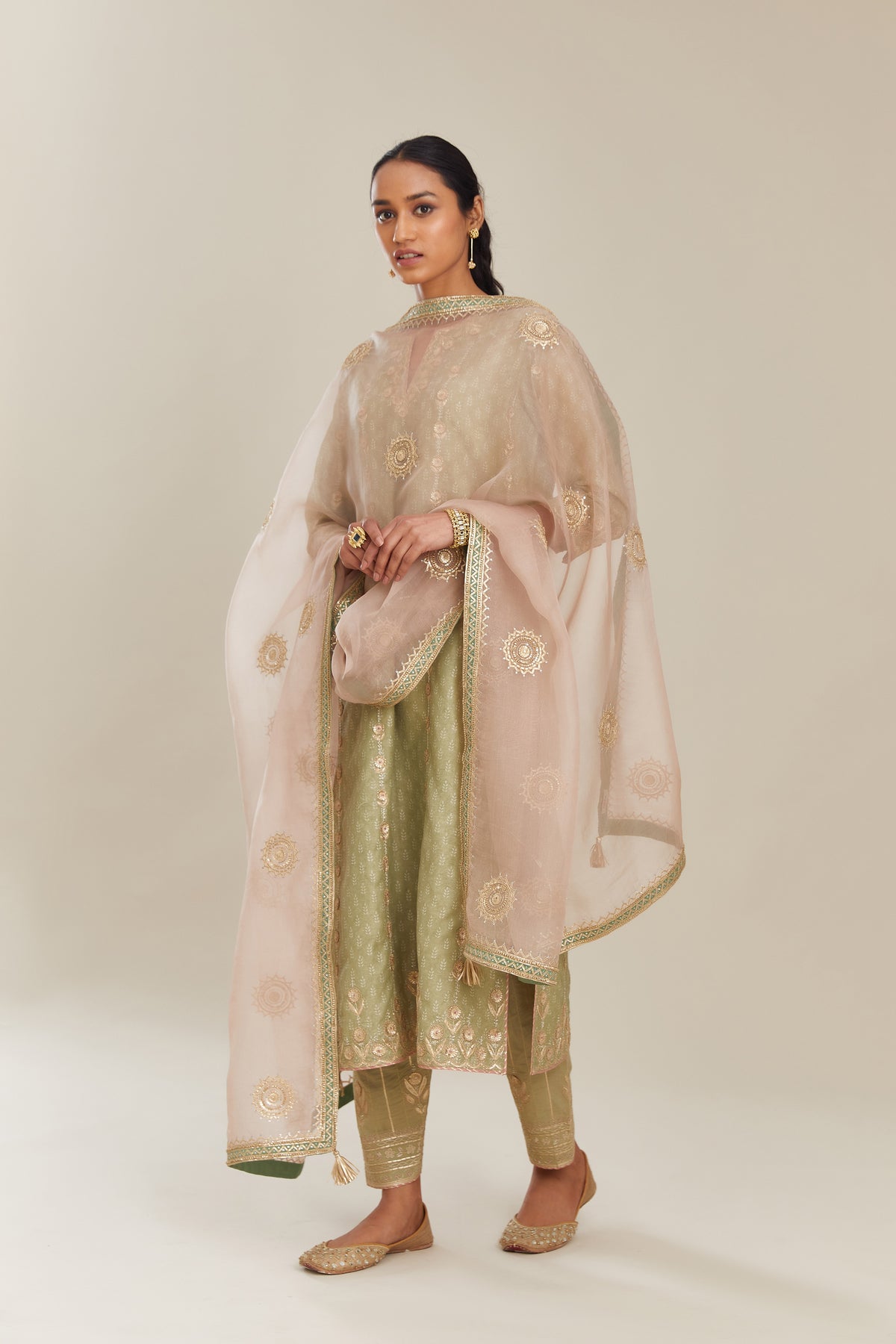 Sage green hand block printed silk chanderi straight kurta set with all over gold gota and zari embroidery.