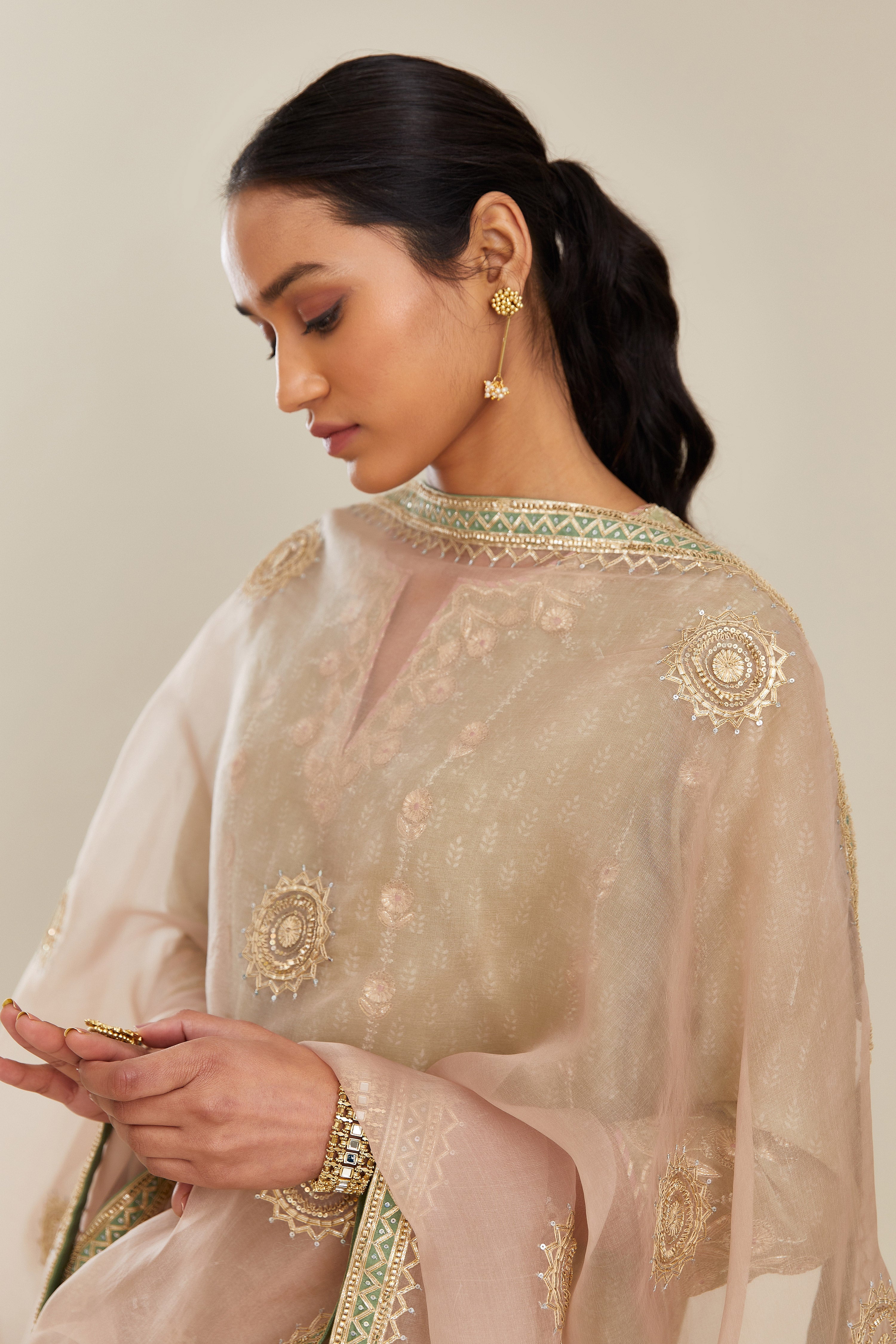 Sage green hand block printed silk chanderi straight kurta set with all over gold gota and zari embroidery.