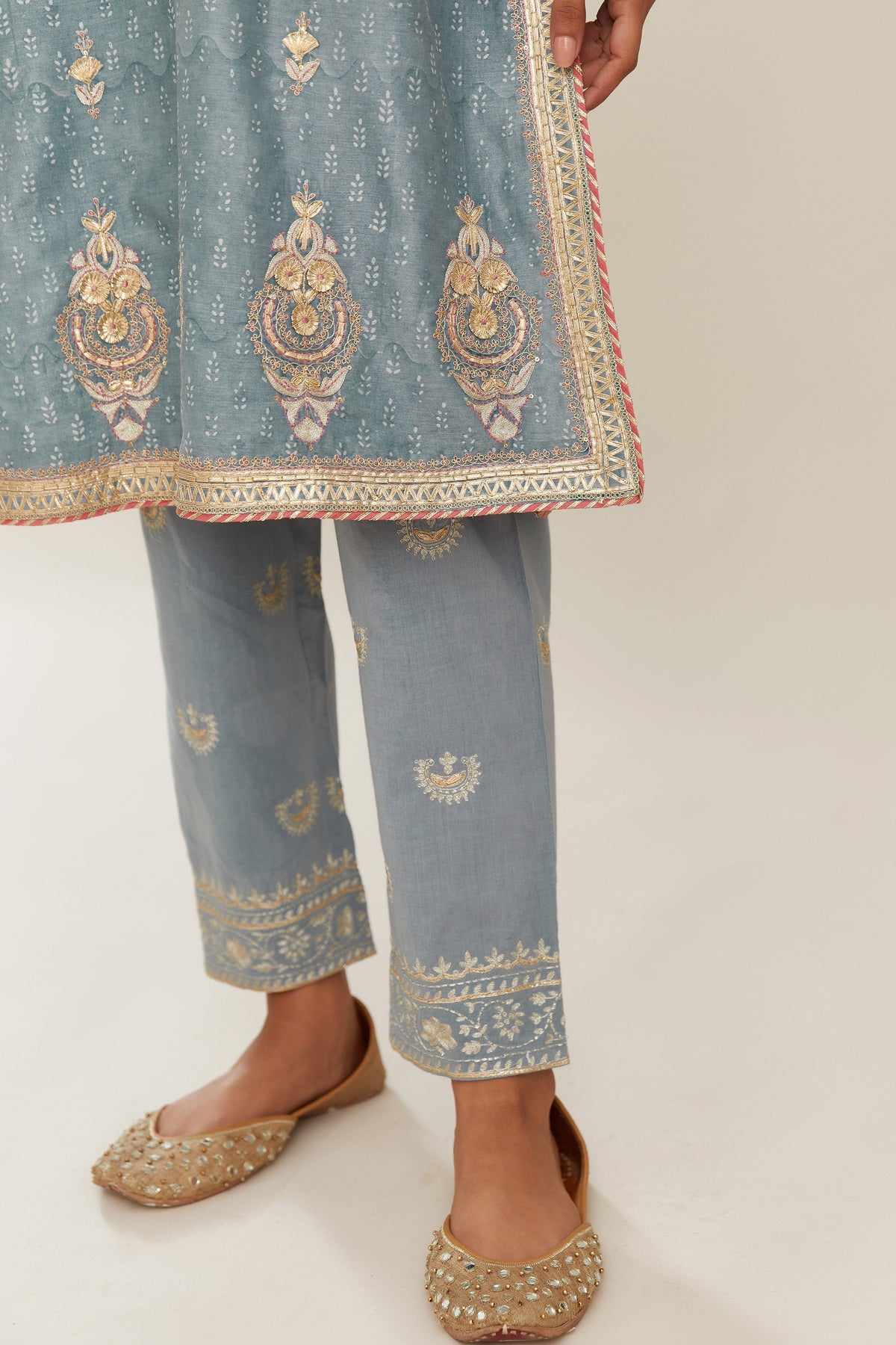 Powder blue hand block printed silk chanderi short kurta set, highlighted with gold gota and zari embroidery.