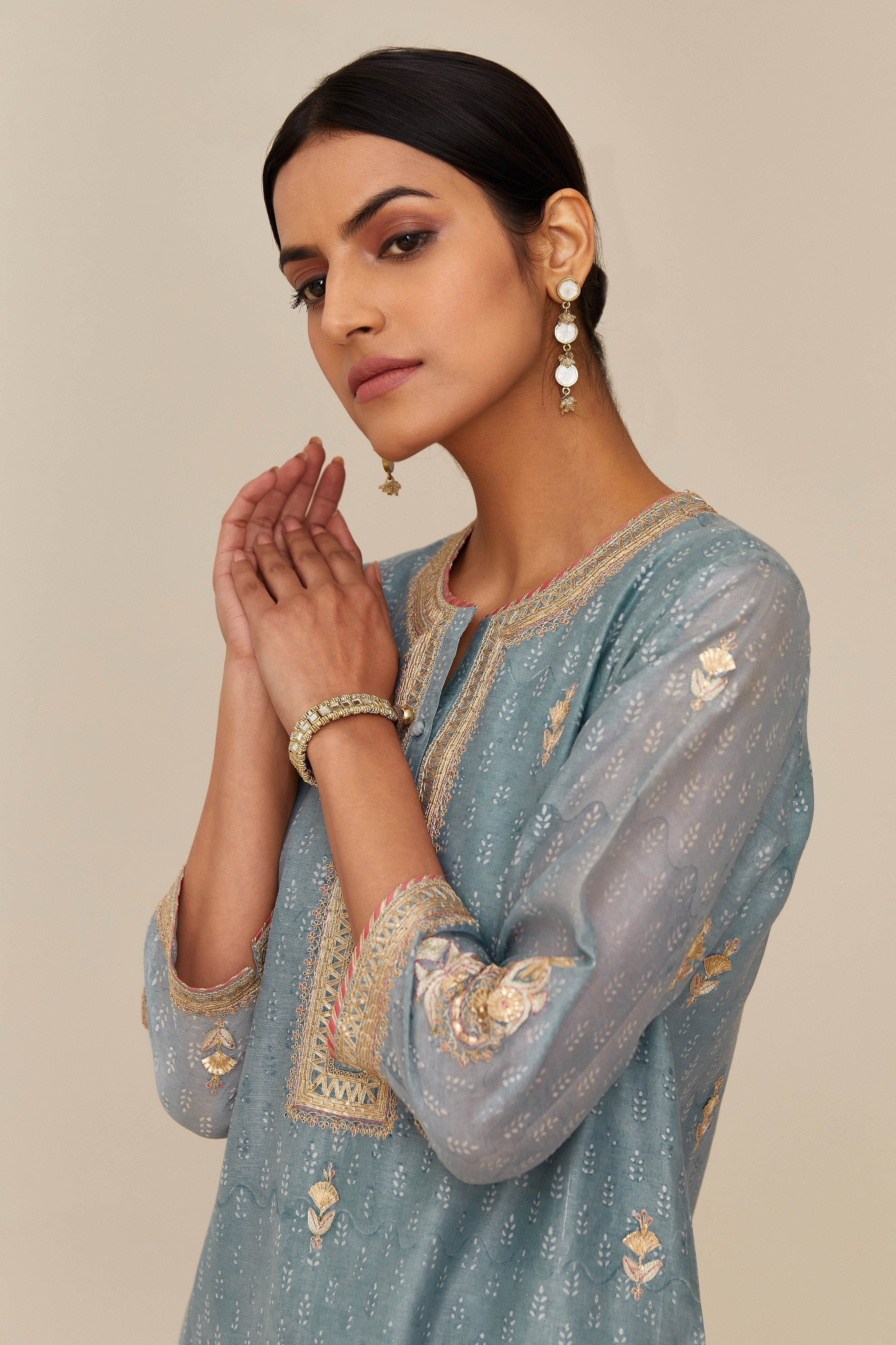 Powder blue hand block printed silk chanderi short kurta set, highlighted with gold gota and zari embroidery.