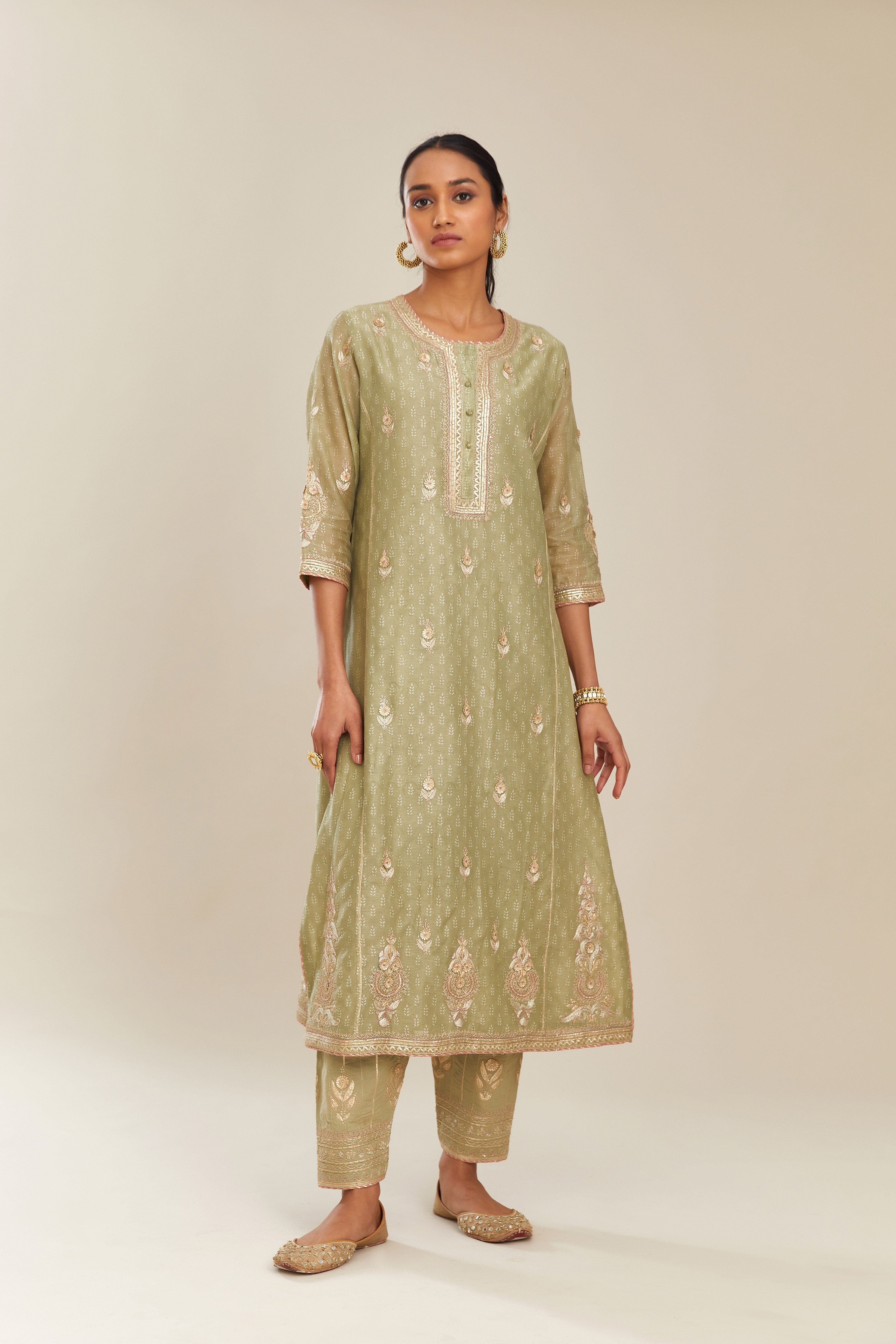 Sage green hand block printed silk chanderi kurta set with side panels, highlighted with gold gota and zari embroidery.