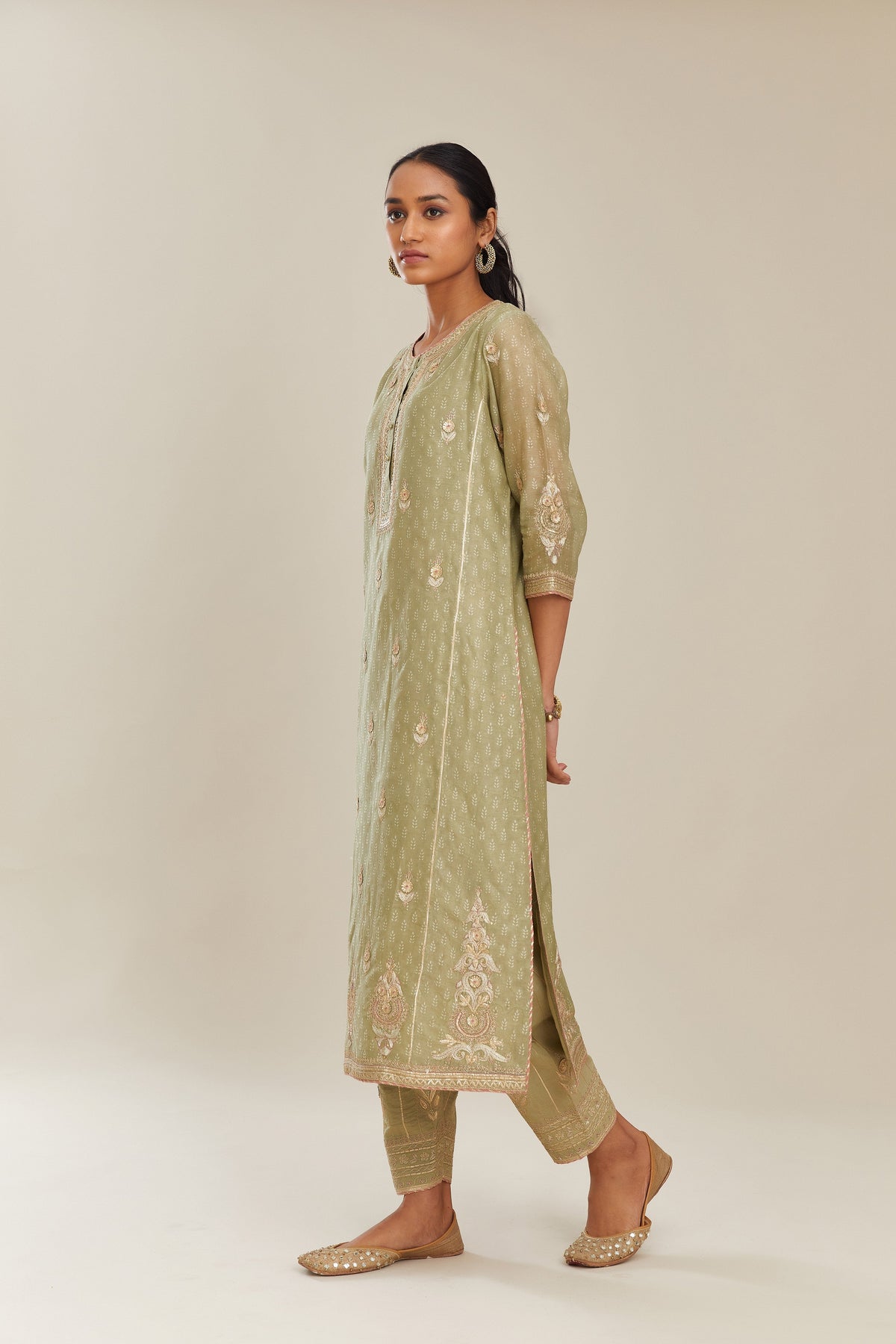 Sage green hand block printed silk chanderi kurta set with side panels, highlighted with gold gota and zari embroidery.