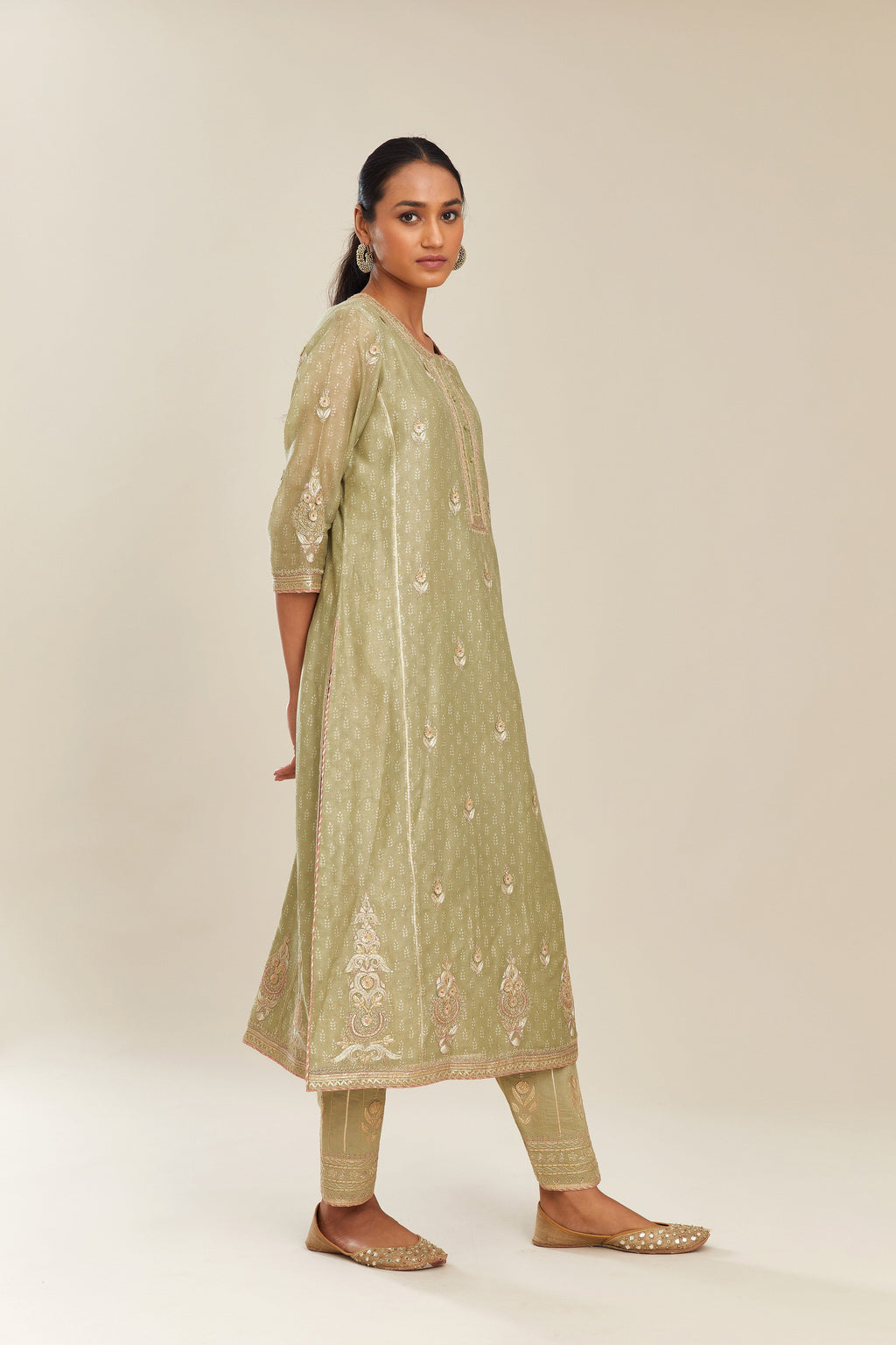 Sage green hand block printed silk chanderi kurta set with side panels, highlighted with gold gota and zari embroidery.