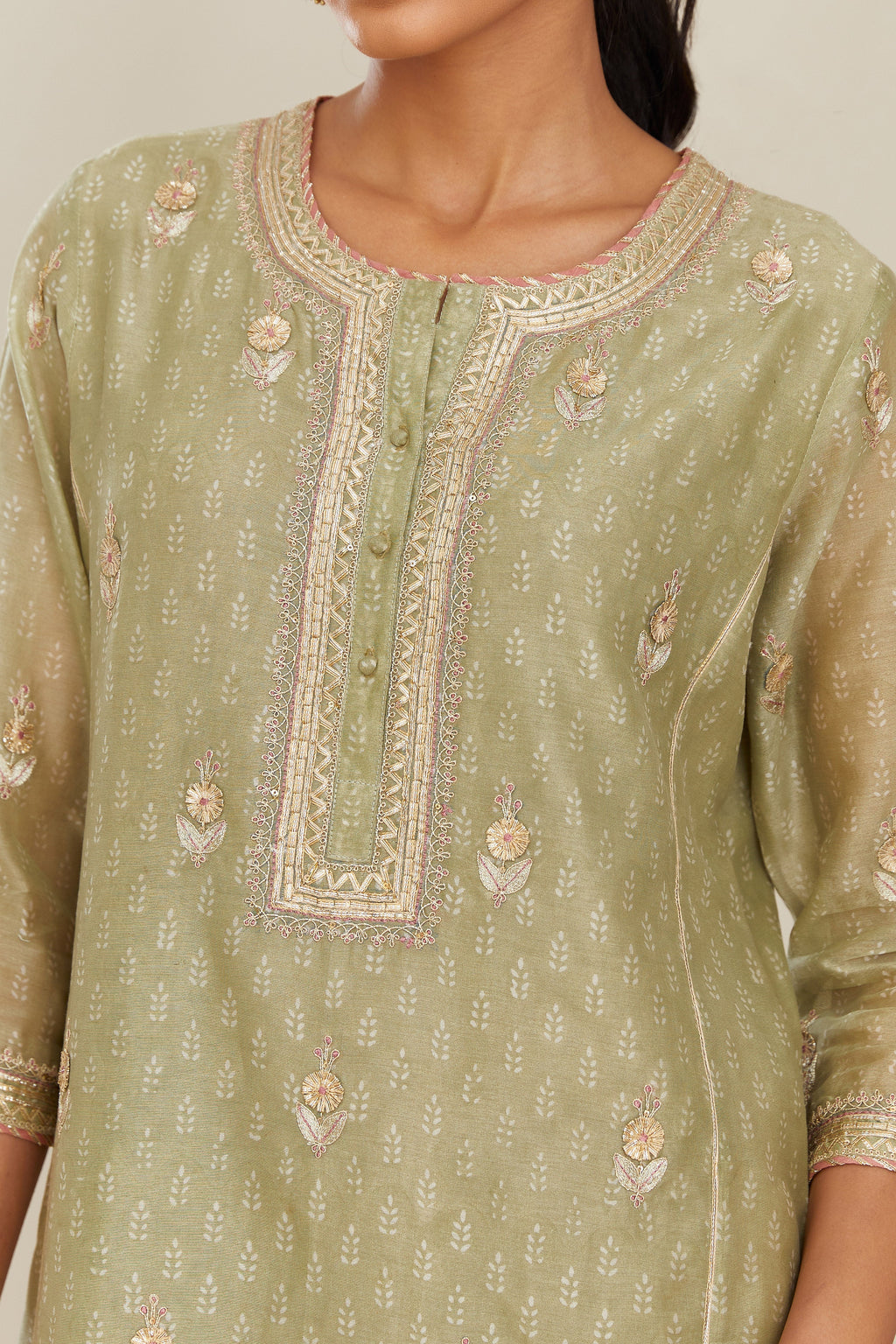 Sage green hand block printed silk chanderi kurta set with side panels, highlighted with gold gota and zari embroidery.