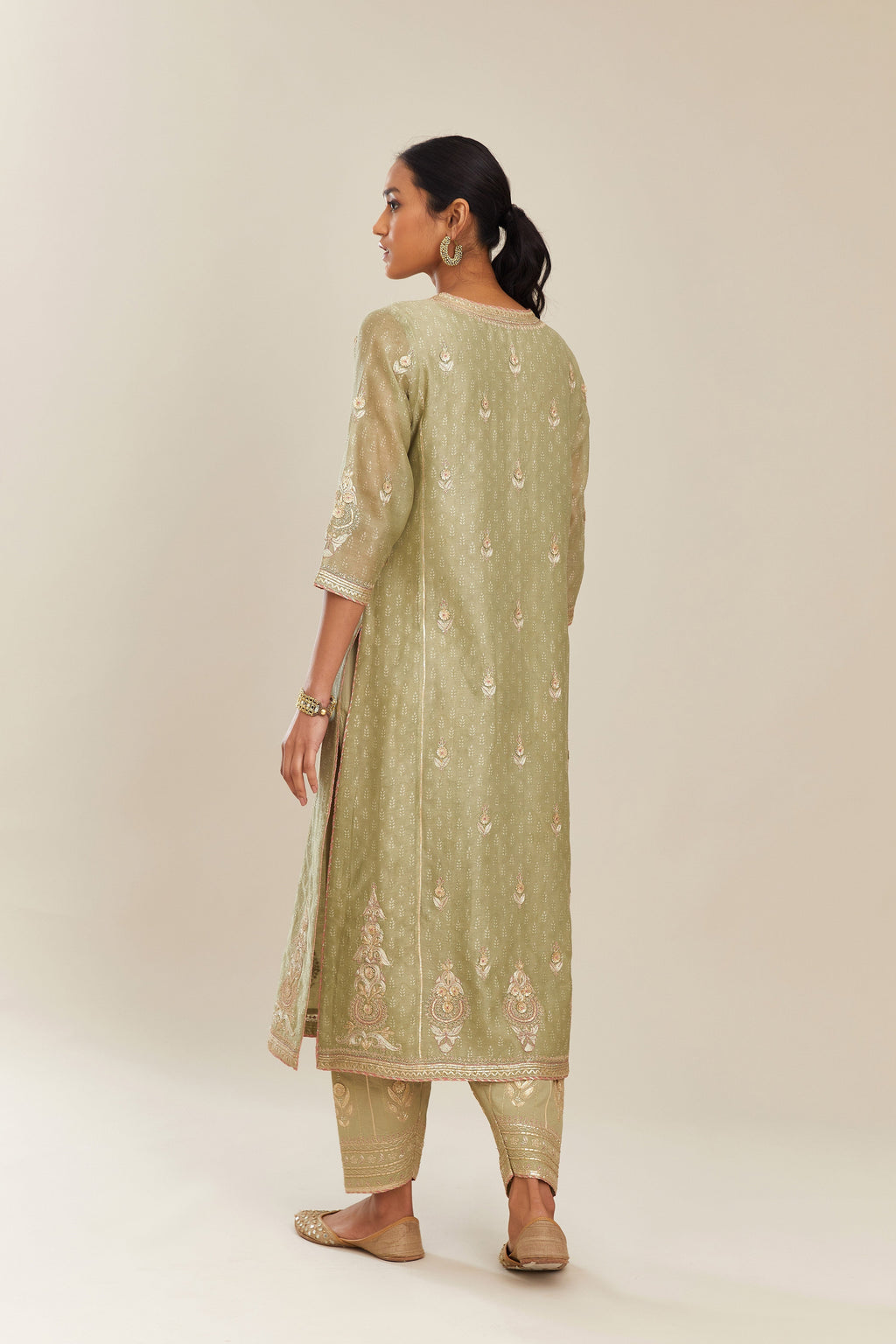 Sage green hand block printed silk chanderi kurta set with side panels, highlighted with gold gota and zari embroidery.