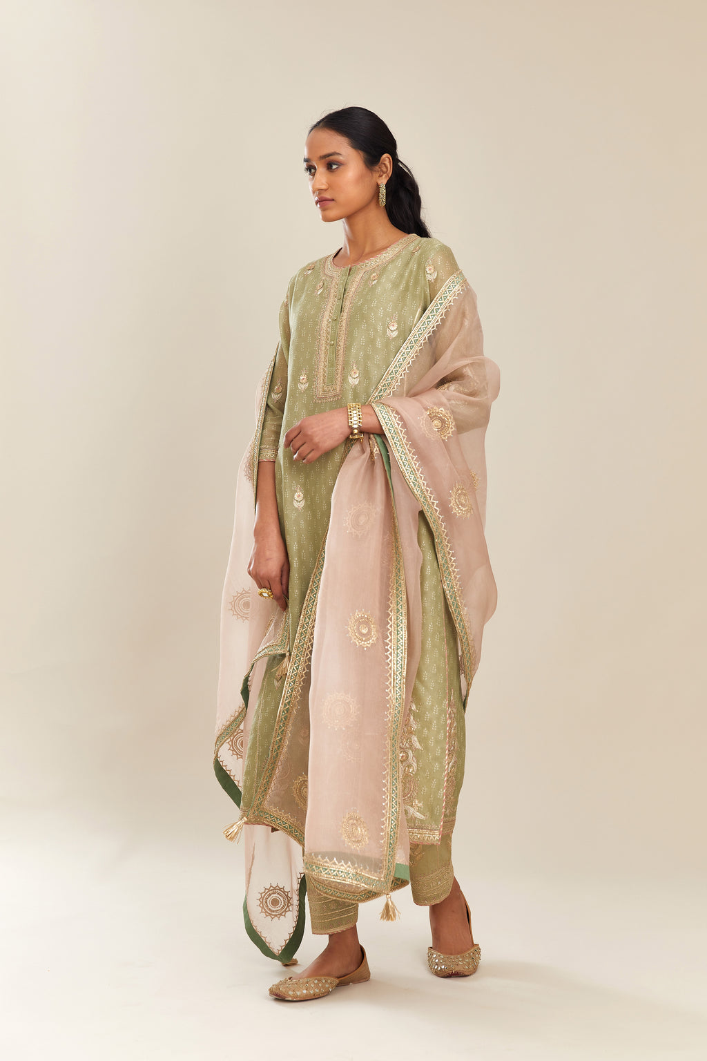 Sage green hand block printed silk chanderi kurta set with side panels, highlighted with gold gota and zari embroidery.