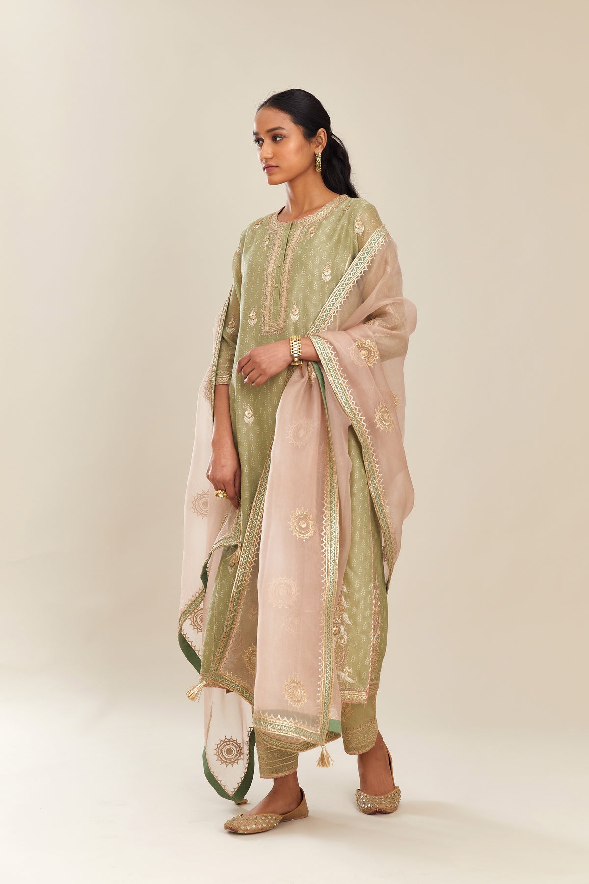 Sage green hand block printed silk chanderi kurta set with side panels, highlighted with gold gota and zari embroidery.