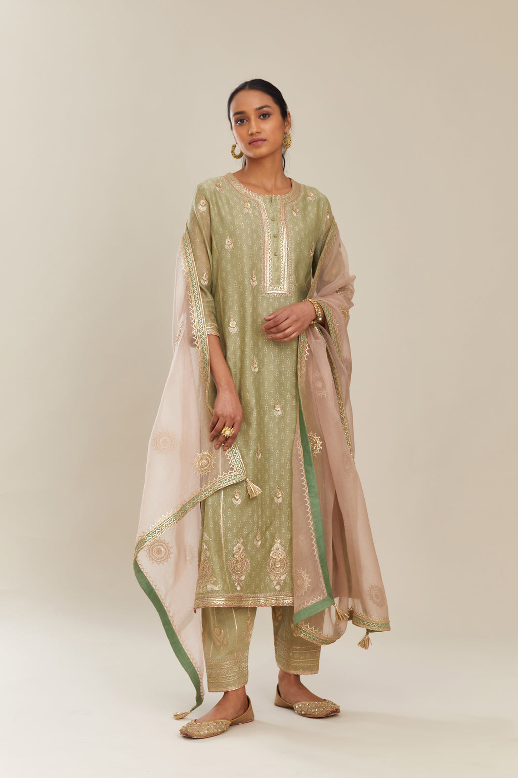 Sage green hand block printed silk chanderi kurta set with side panels, highlighted with gold gota and zari embroidery.