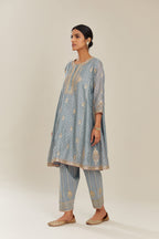 Powder blue hand block printed short kalidar silk chanderi kurta set with button placket and all over gold gota and zari embroidery.