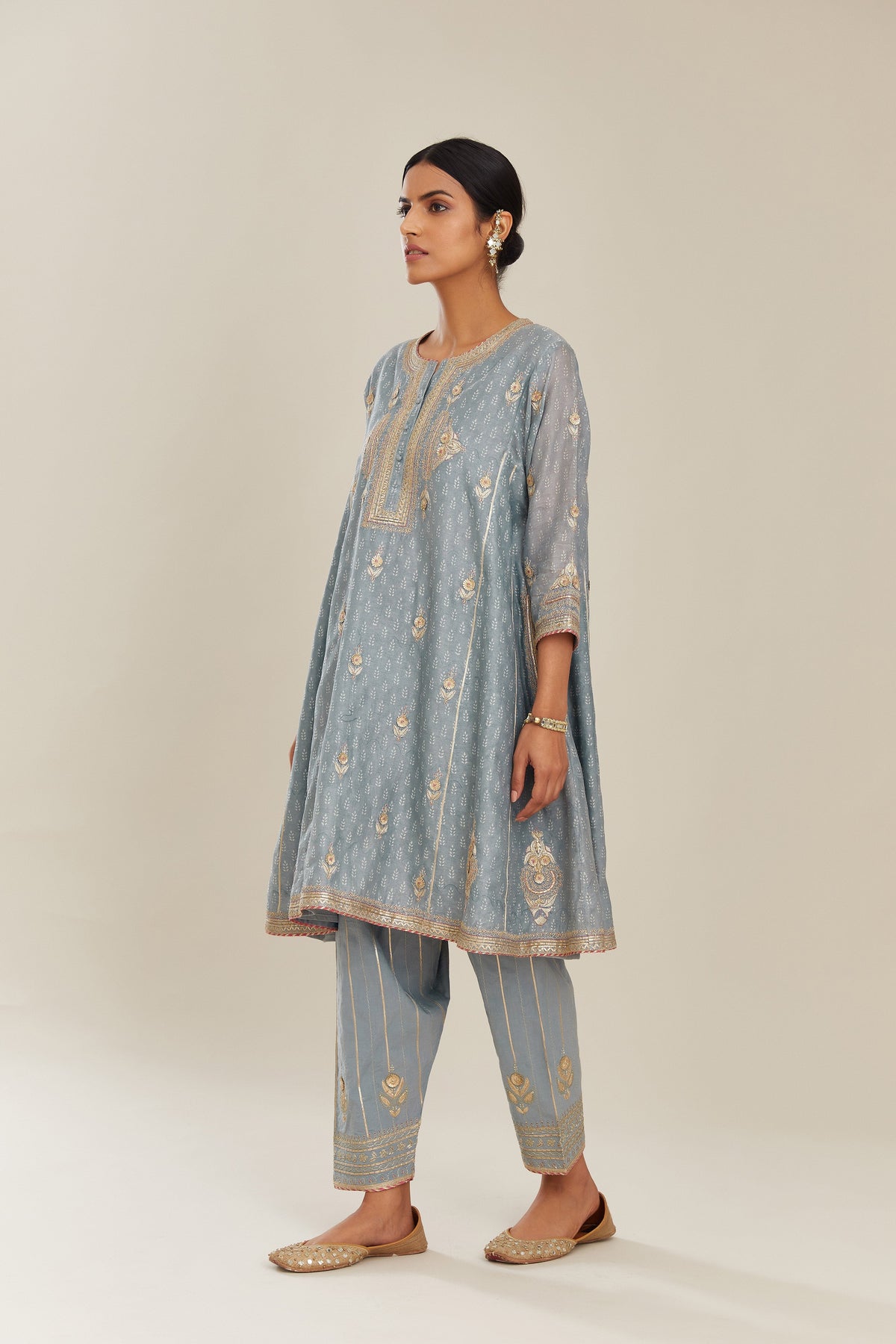 Powder blue hand block printed short kalidar silk chanderi kurta set with button placket and all over gold gota and zari embroidery.
