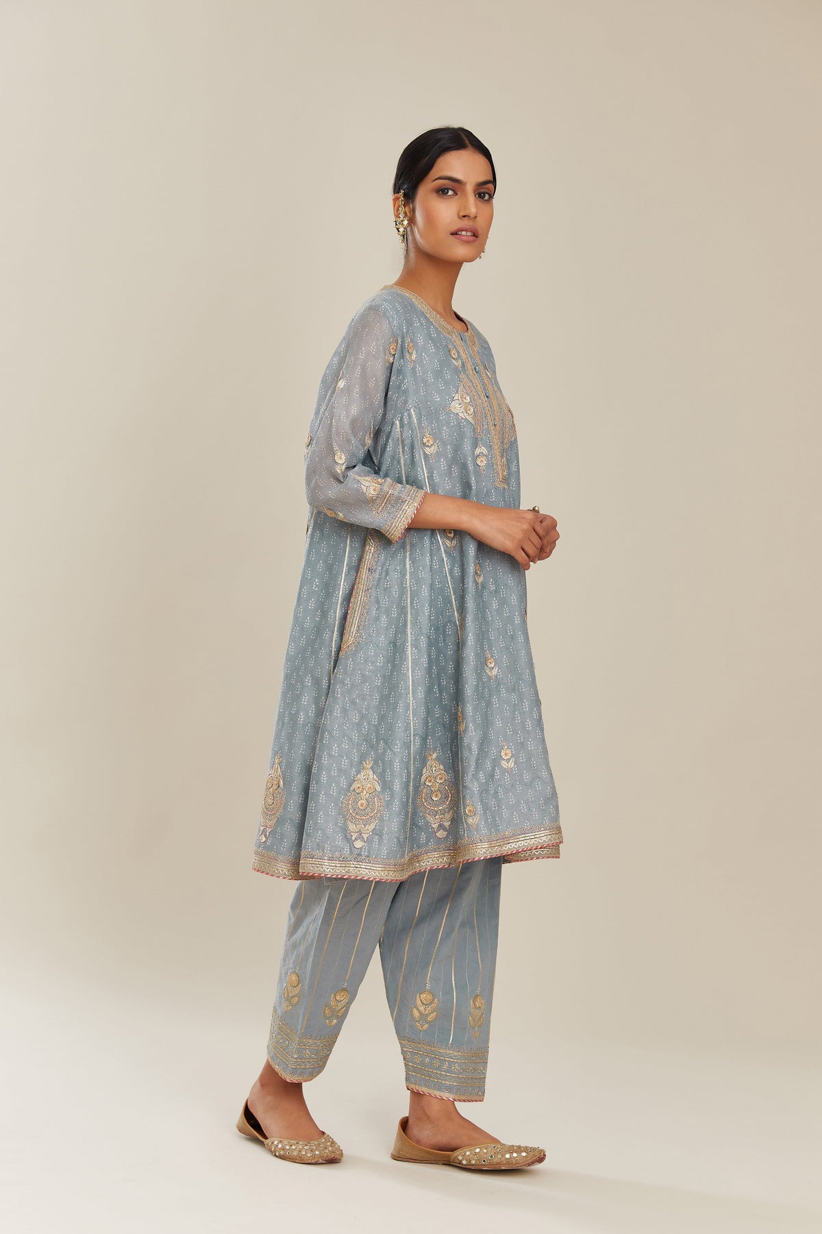 Powder blue hand block printed short kalidar silk chanderi kurta set with button placket and all over gold gota and zari embroidery.