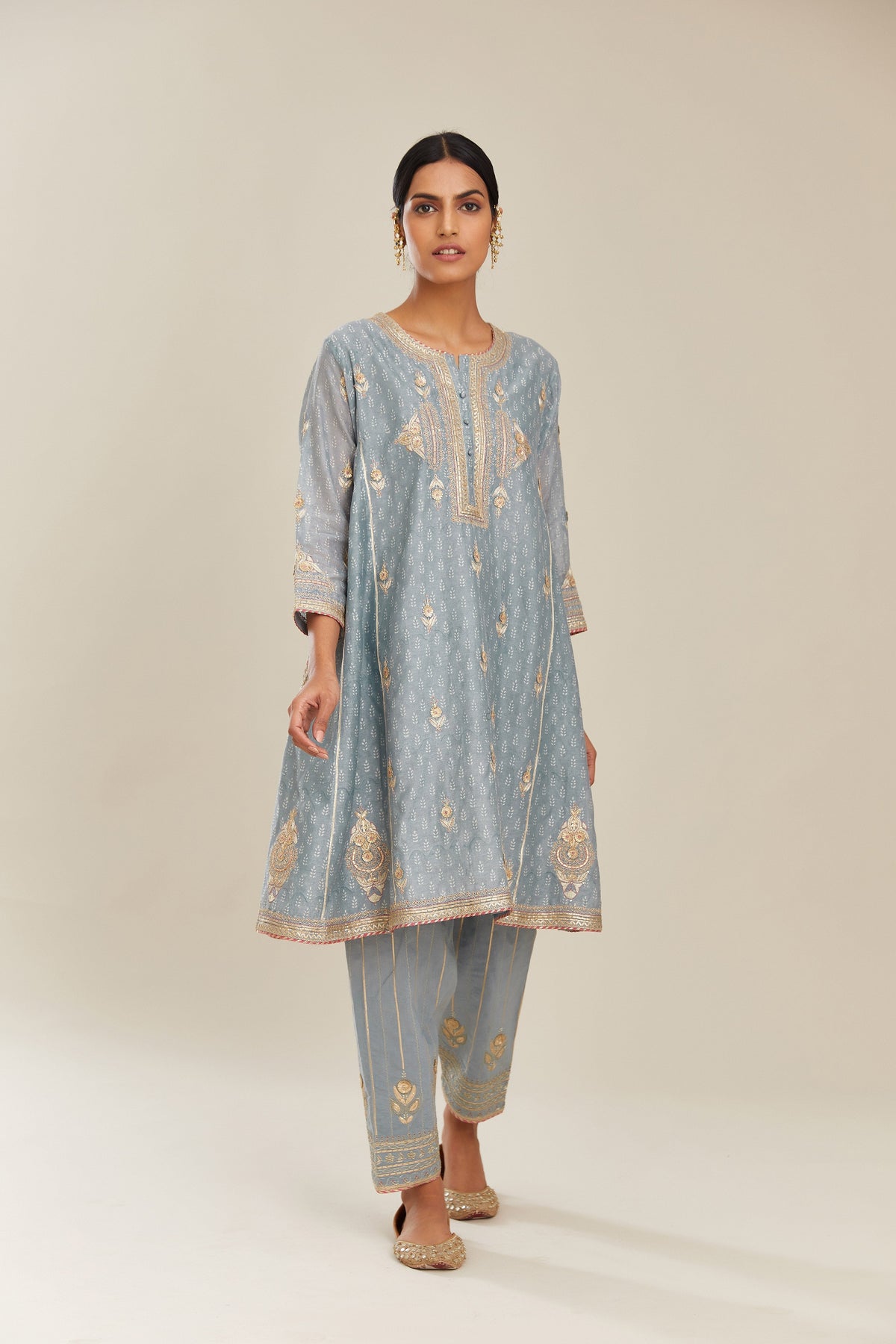 Powder blue hand block printed short kalidar silk chanderi kurta set with button placket and all over gold gota and zari embroidery.