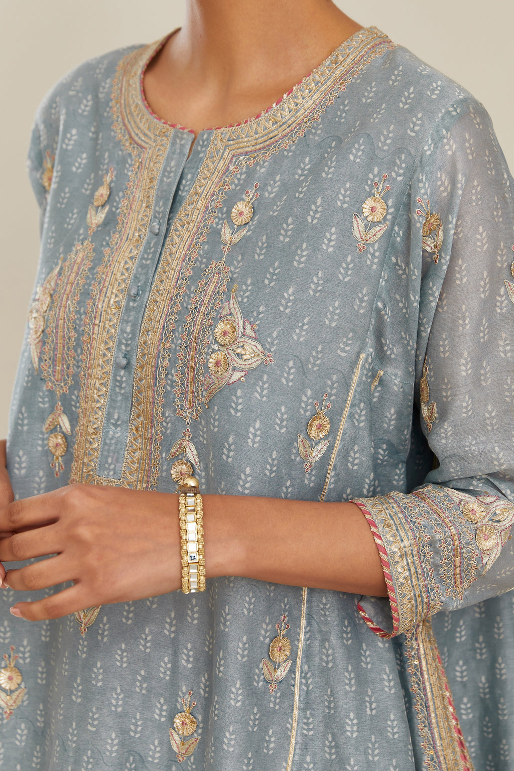 Powder blue hand block printed short kalidar silk chanderi kurta set with button placket and all over gold gota and zari embroidery.