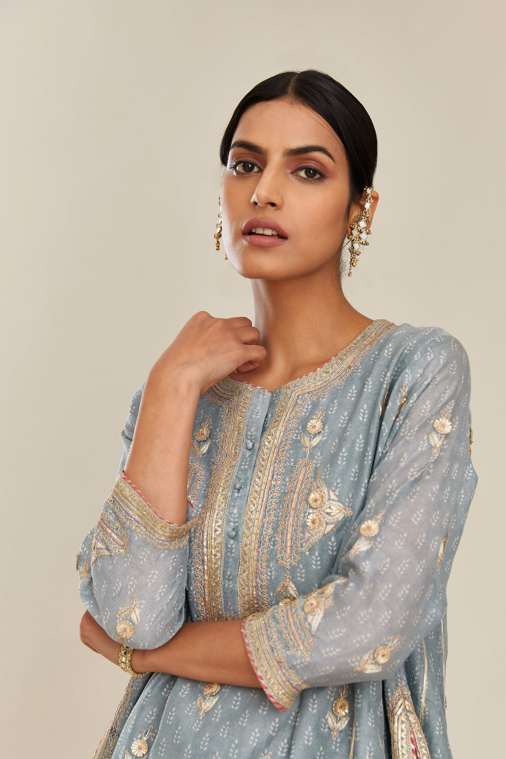 Powder blue hand block printed short kalidar silk chanderi kurta set with button placket and all over gold gota and zari embroidery.