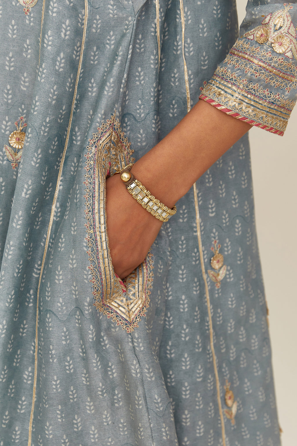 Powder blue hand block printed short kalidar silk chanderi kurta set with button placket and all over gold gota and zari embroidery.
